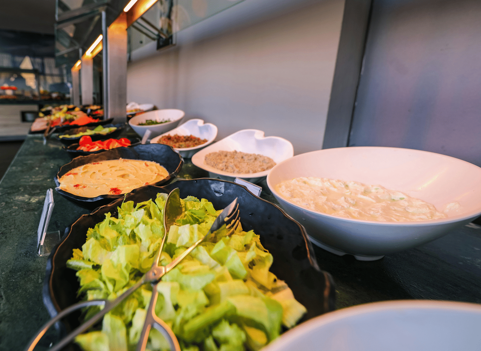 An indoor buffet set up with open bowls showcasing the variety of dishes.