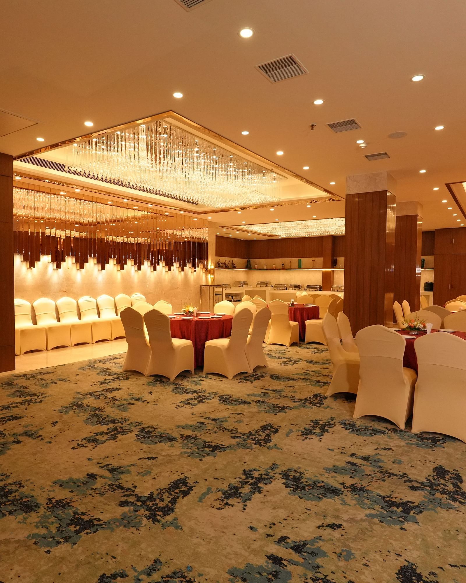 Well-lit banquet hall with elegant seating and carpeted flooring - Grand Plaza Lords Inn Jammu