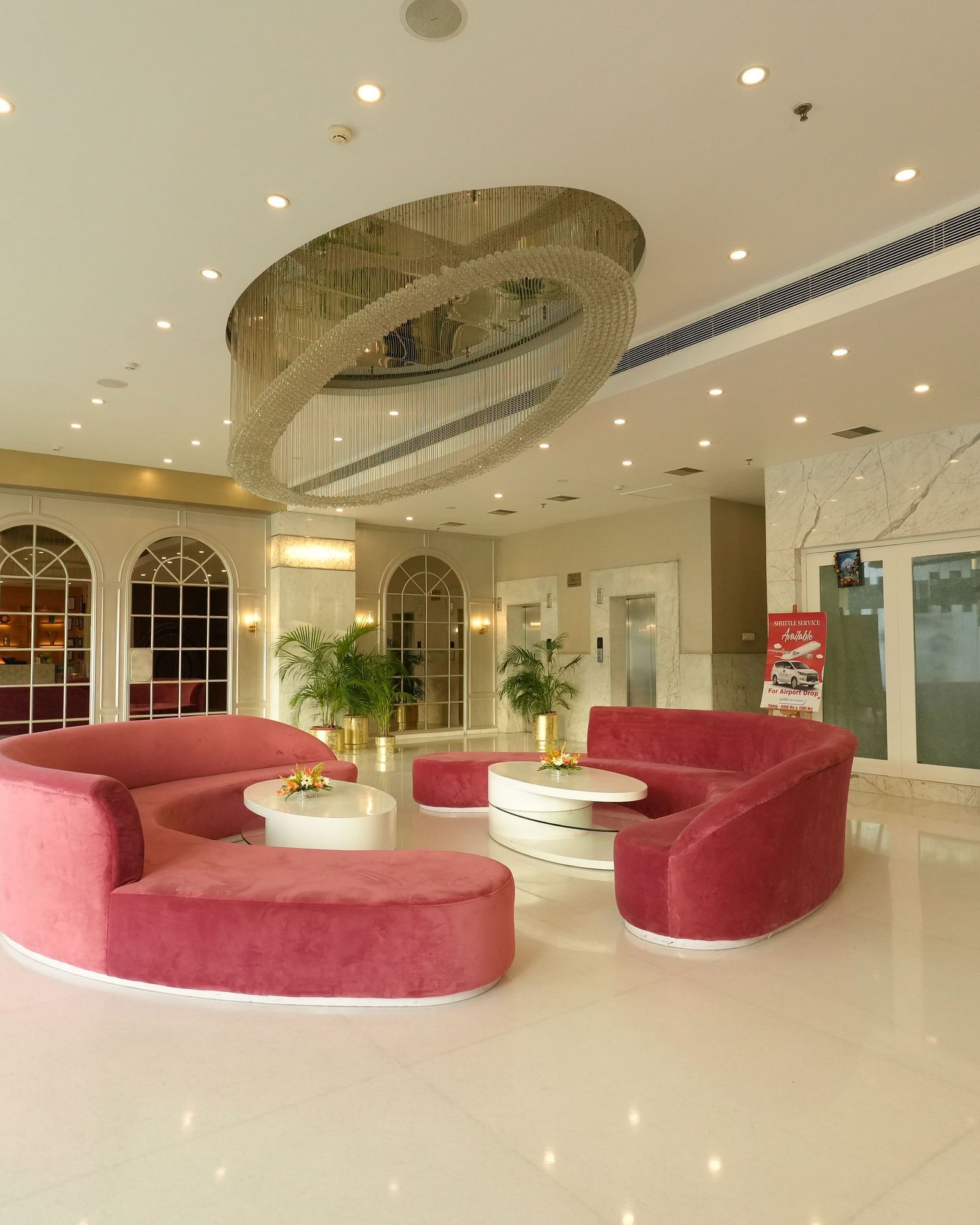 Hotel lobby with modern décor and curved pink seating - Grand Plaza Lords Inn Jammu