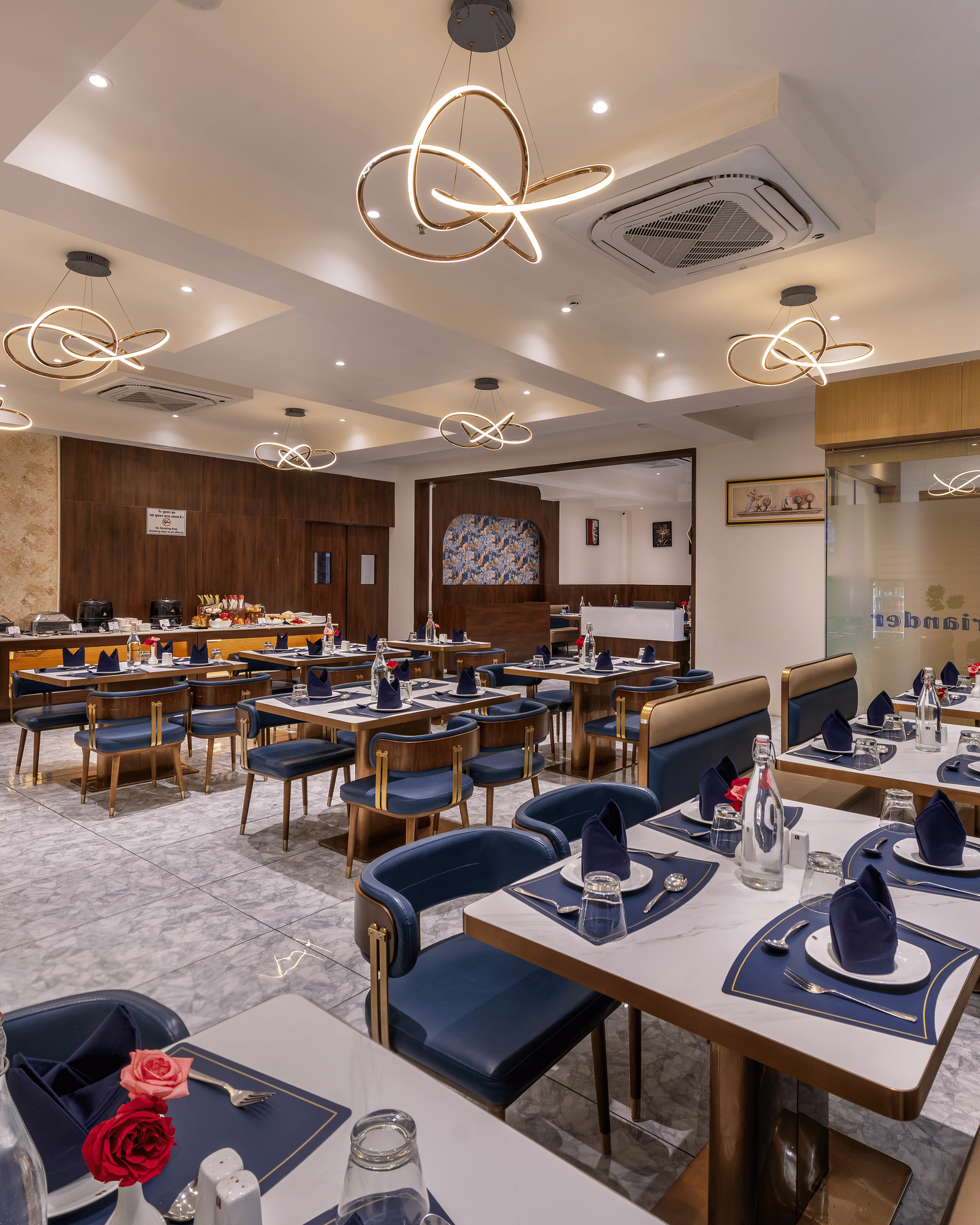 In-house dining area with neatly arranged tables and bright interiors at Lords Studio Inn, Jamnagar.