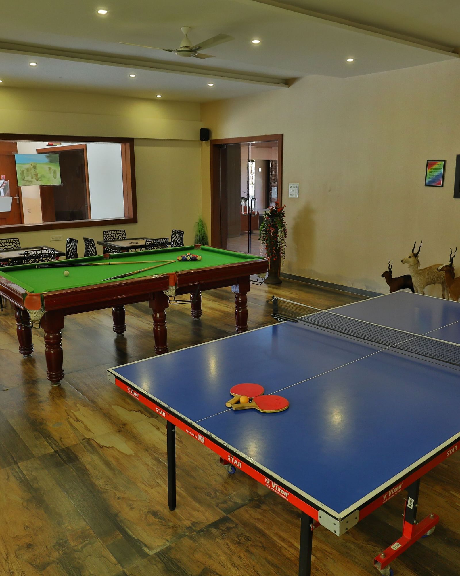 Games room with a pool table, table tennis table, and chairs - Vishal Lords Inn Gir Forest