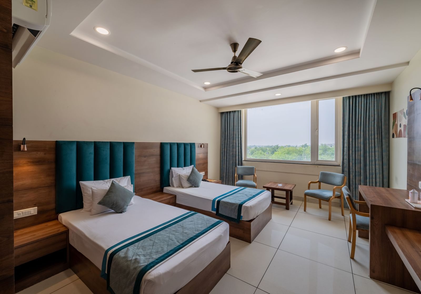 Spacious King Twin Bed Room with window seating, work station, ceiling fan, and modern amenities at Hotel Highway King, Bilaspur.