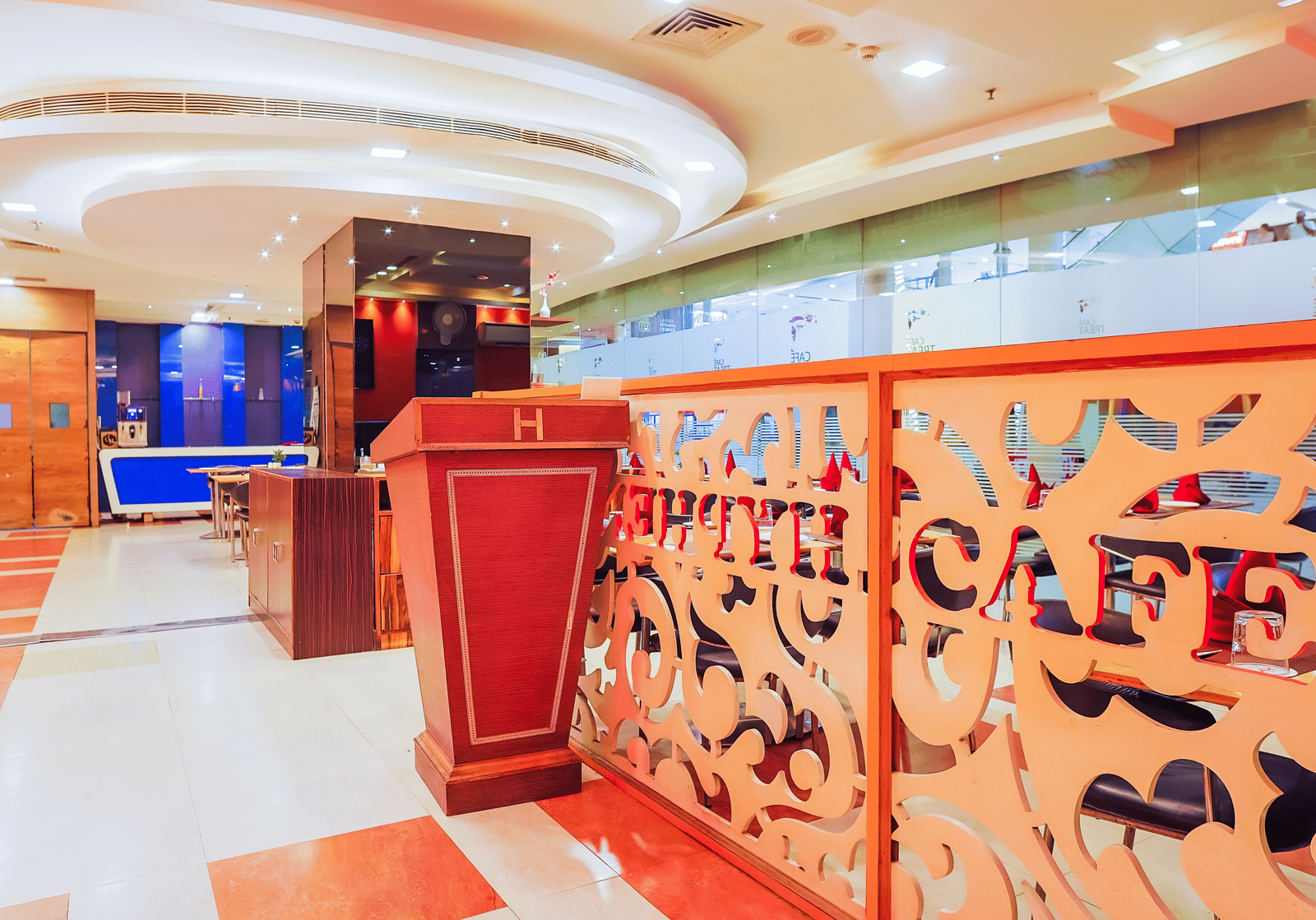 Entrance of Cafe Treat restaurant with partition at Hyphen Premier Hotel, Meerut.