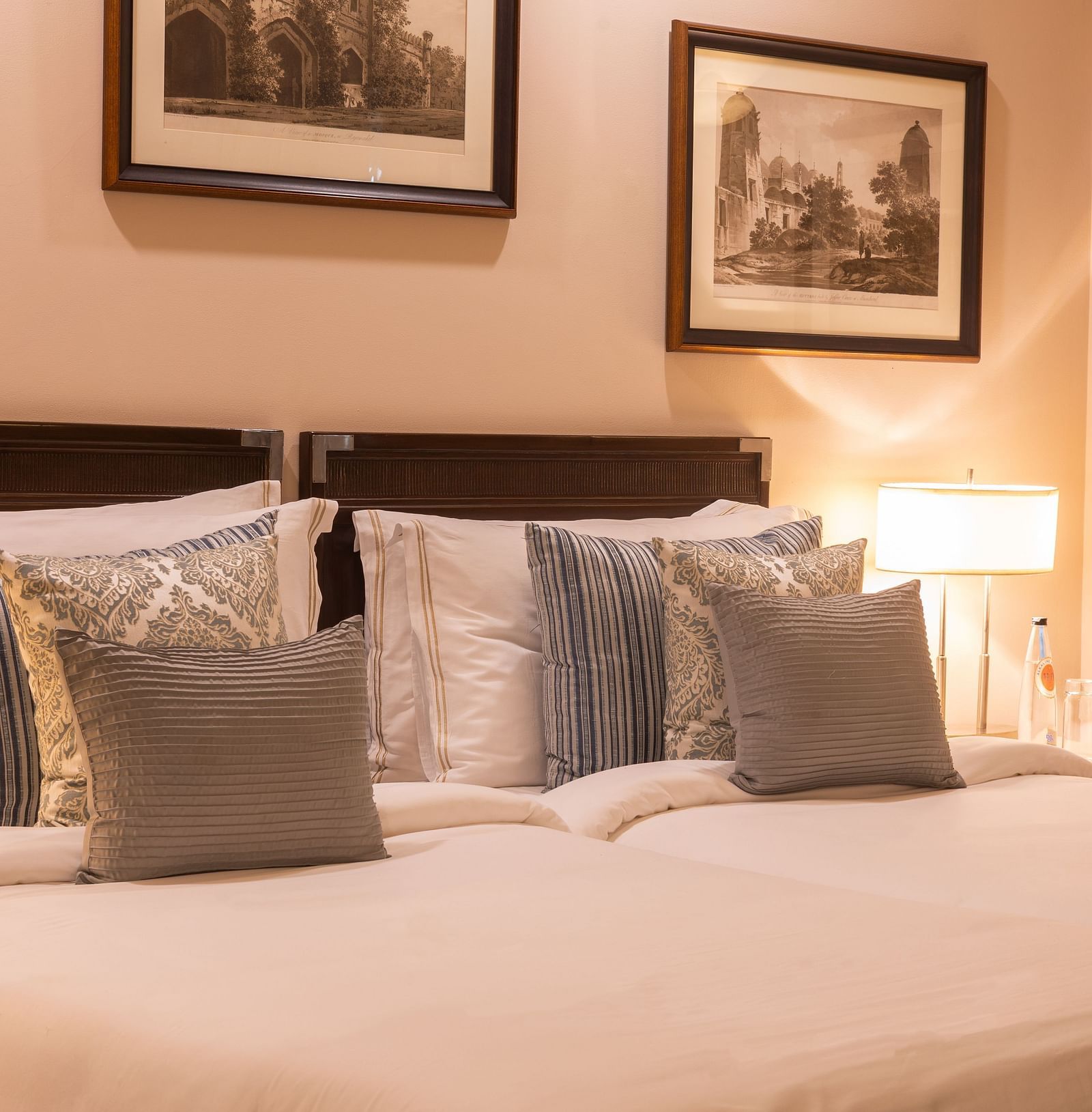 Side view of the Superior Twin Bed Room at The Claridges New Delhi, showcasing twin beds and a bedside lamp