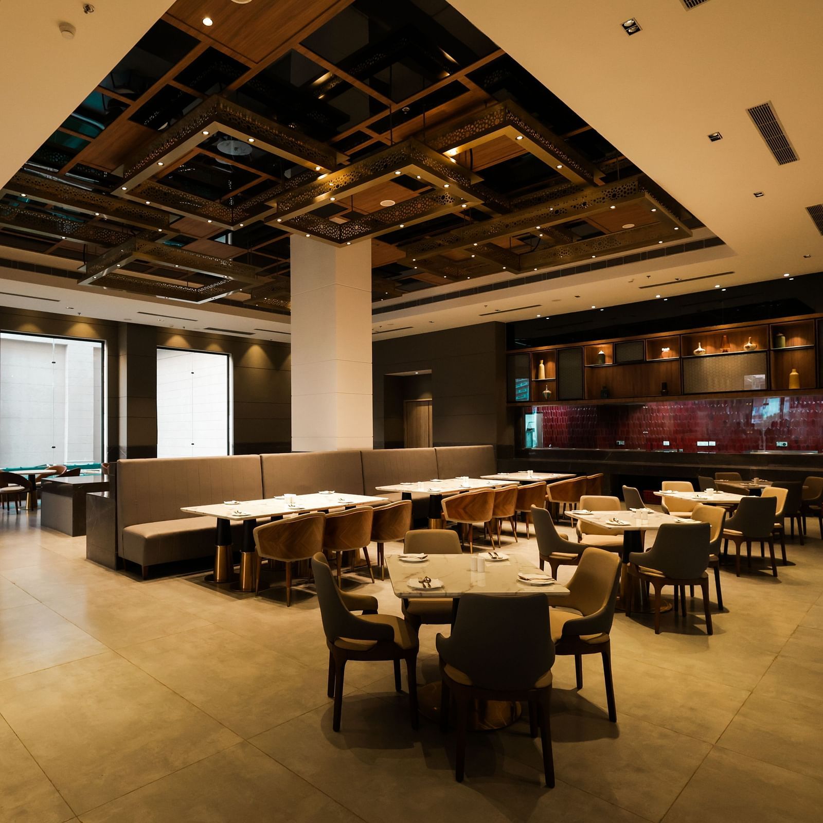 Warmly lit restaurant with elegant ceiling design at Ramada by Wyndham Sonipat Murthal