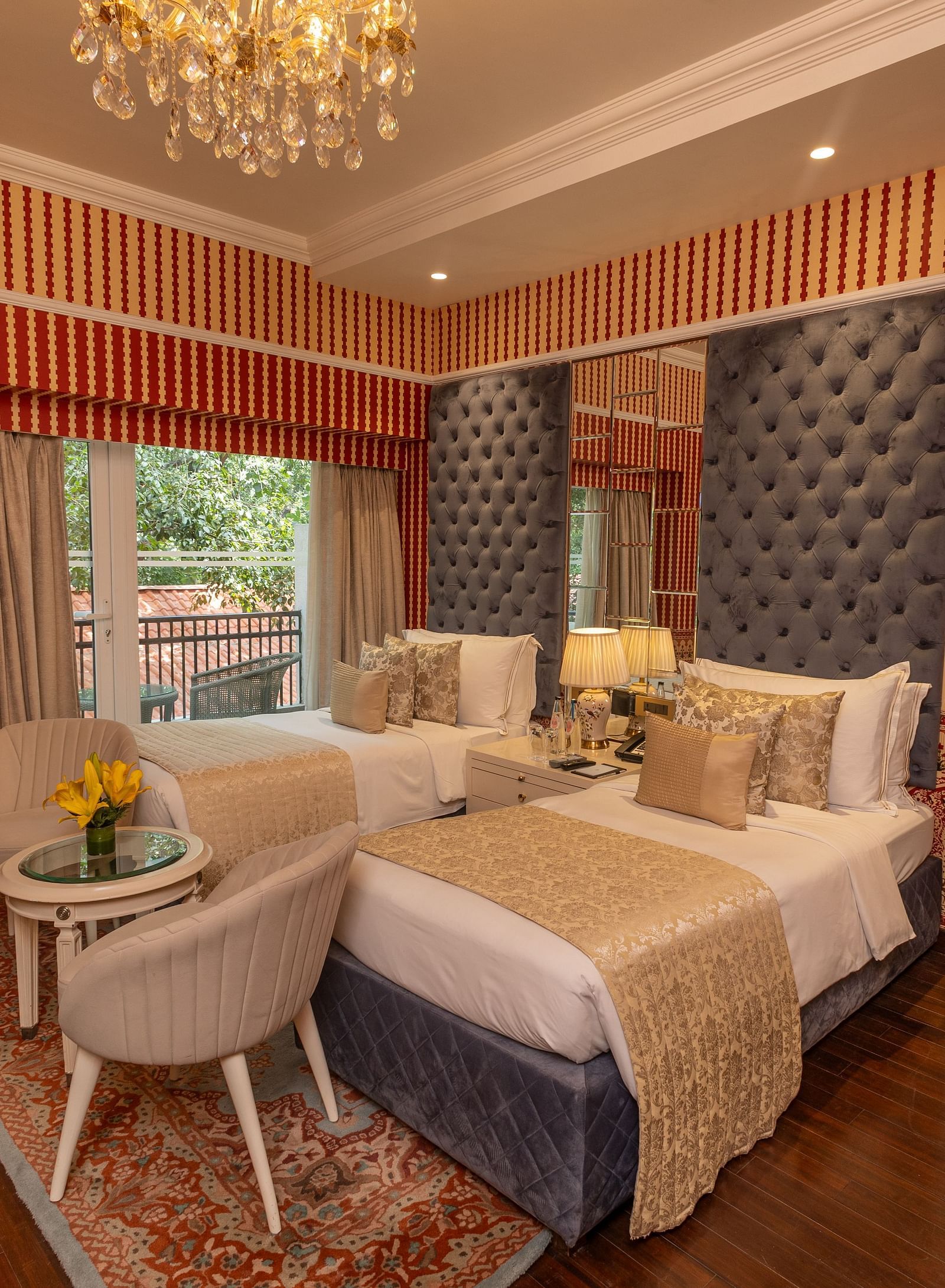 Luxury Twin Bed Room with Balcony at The Claridges New Delhi, featuring twin beds with pillows and a large window with a view