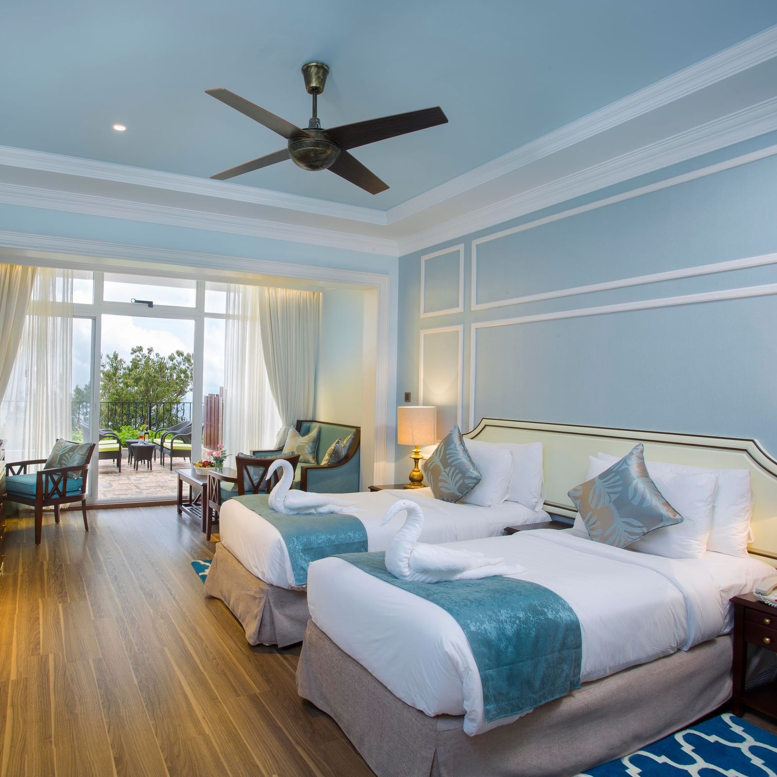  Aerial view of the hotel nestled among trees, with a breathtaking mountain vista in the background.