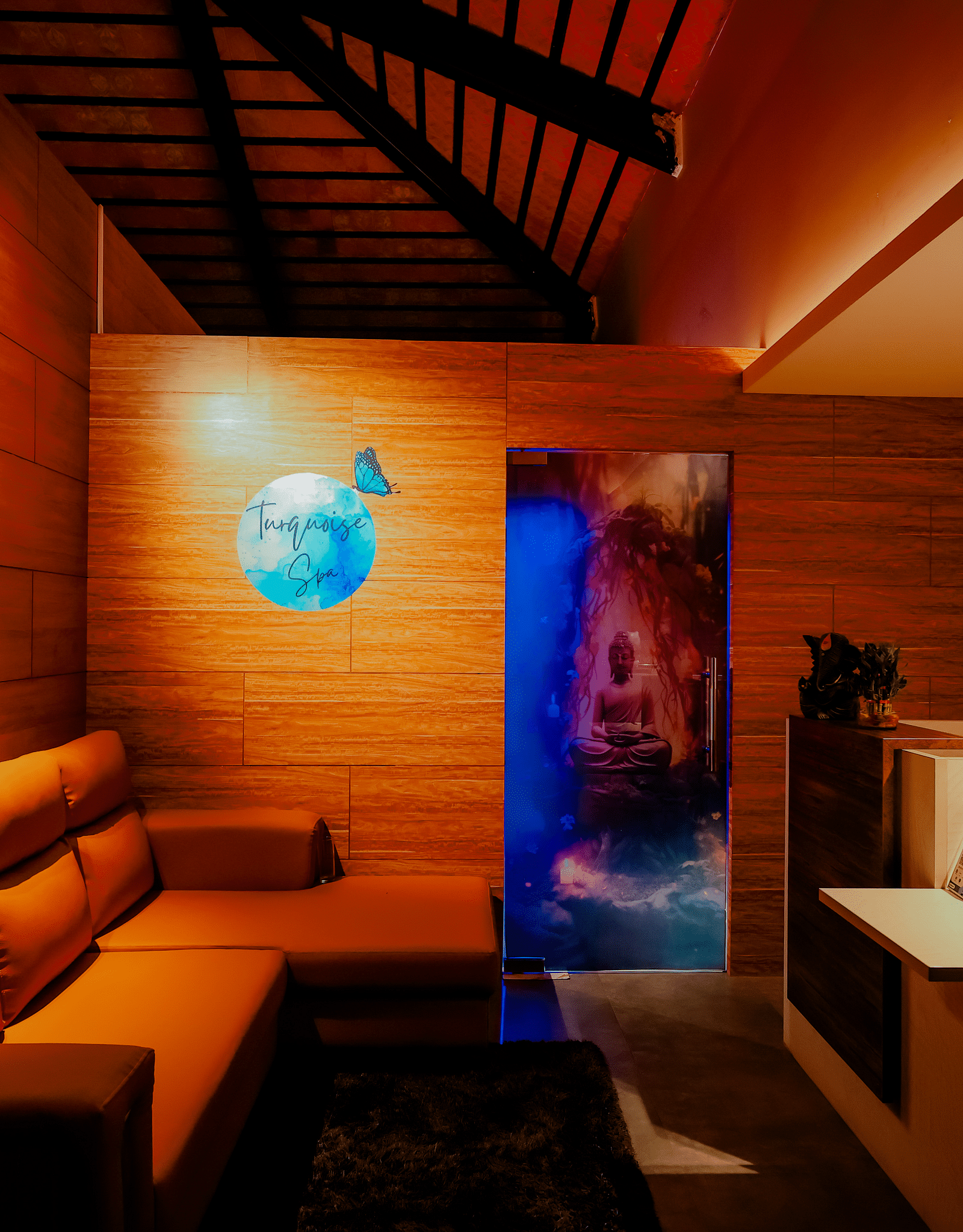 A dimly lit lounge or relaxation area at Nirantara Resort & Spa with comfortable seating and warm lighting.