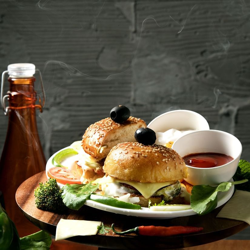 burgers and dips on a plate