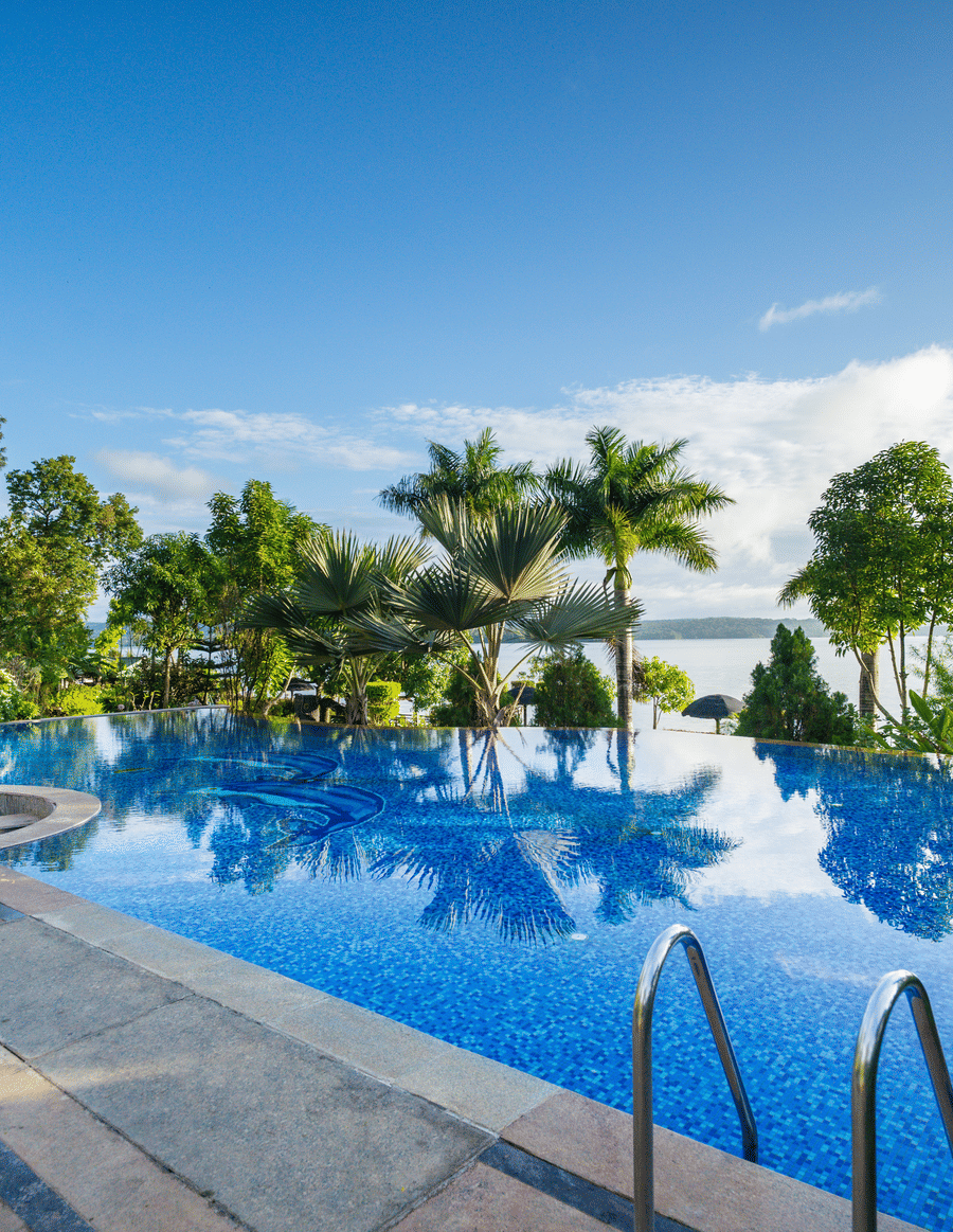 Image of a swimming pool with trees surrounding it at Coorg Jungle Camp Backwater Resort, Kushalnagar.