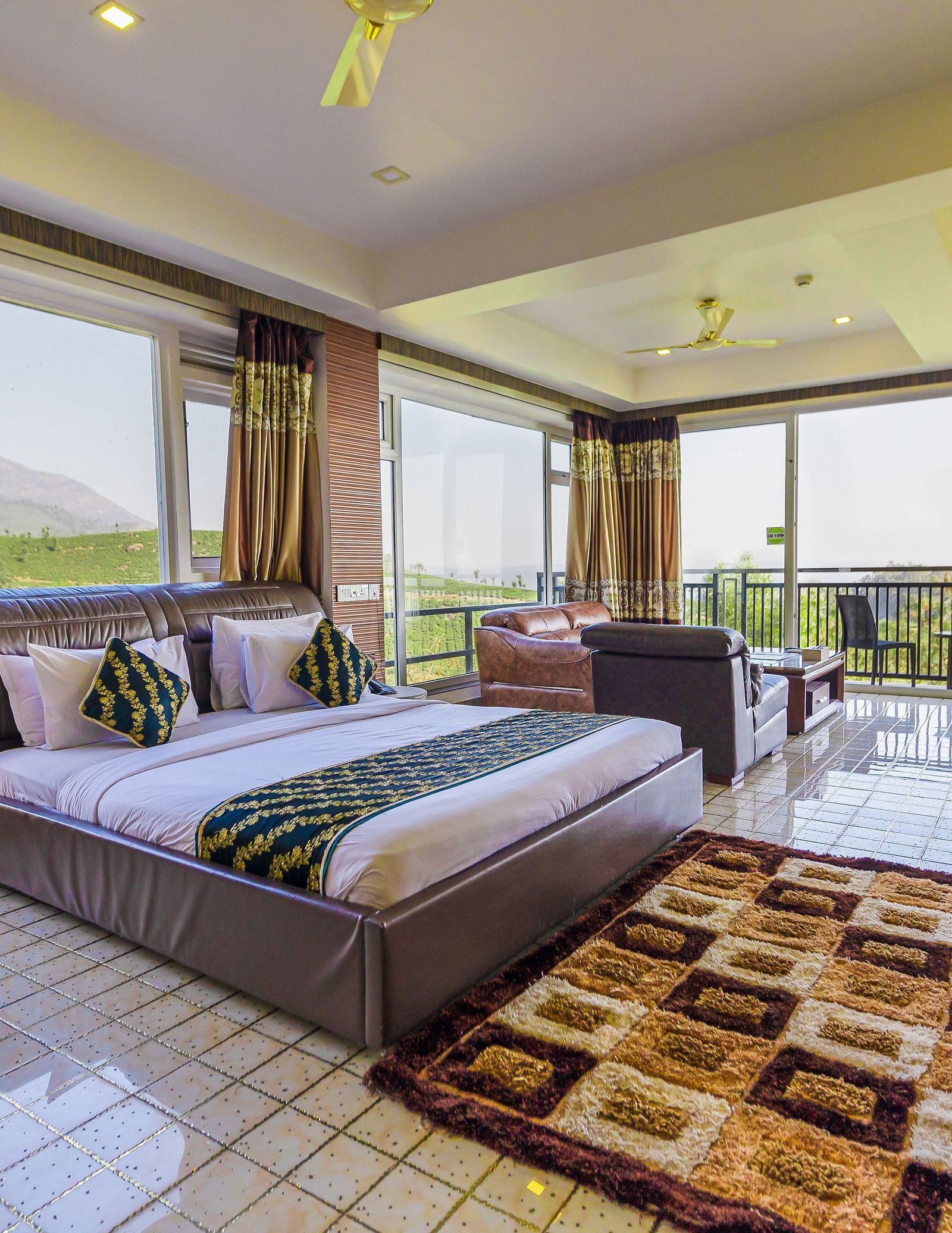 A double bed with 180 degree view of the plantation in the 180 Degree Club Suite at Parakkat Nature Hotel and Resorts Munnar 2