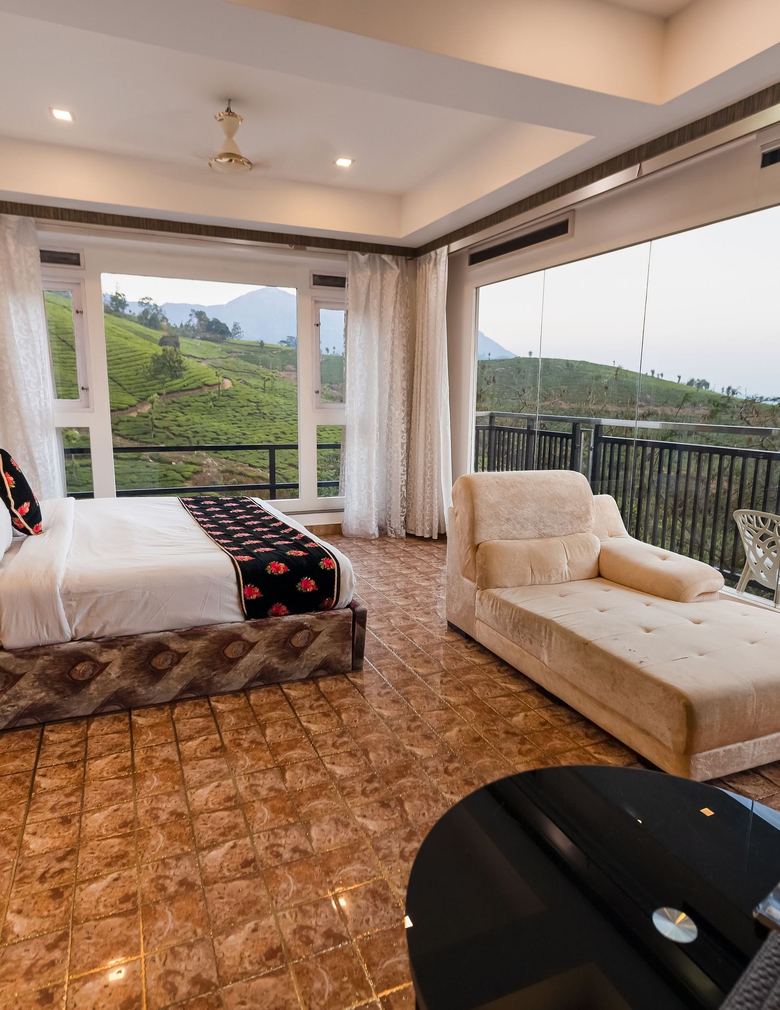 Side view of the bed and sofas at the Family Interconnected Club Suite Parakkat Nature Hotel and Resorts Munnar 1