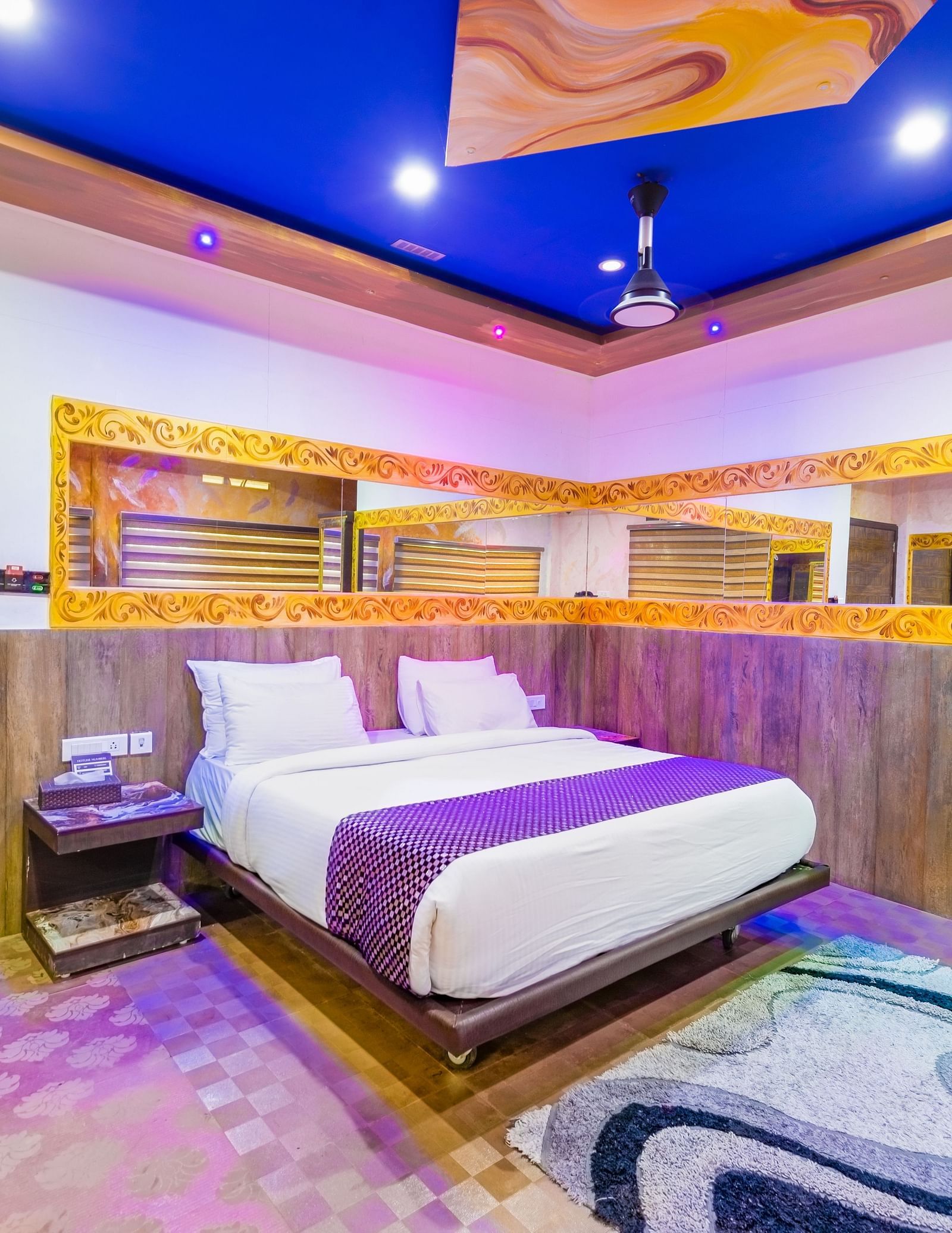 Side view of the double bed with blue ceiling in the Jungle Room at Parakkat Nature Hotel and Resorts Munnar 3