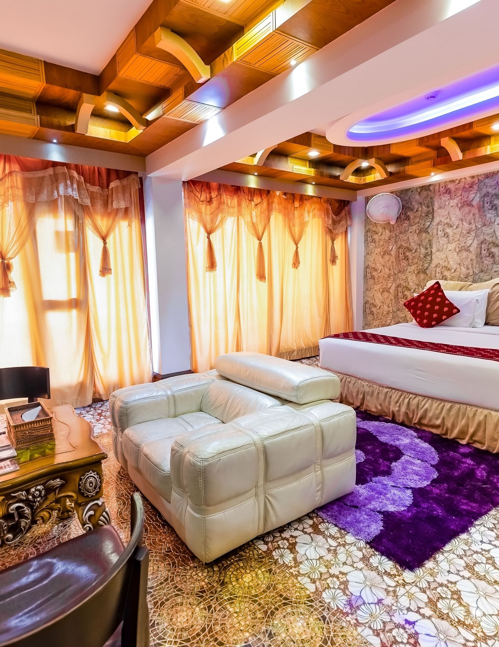 Living area and king size bed in the Presidential Suite at Parakkat Nature Hotel and Resorts Munnar 5