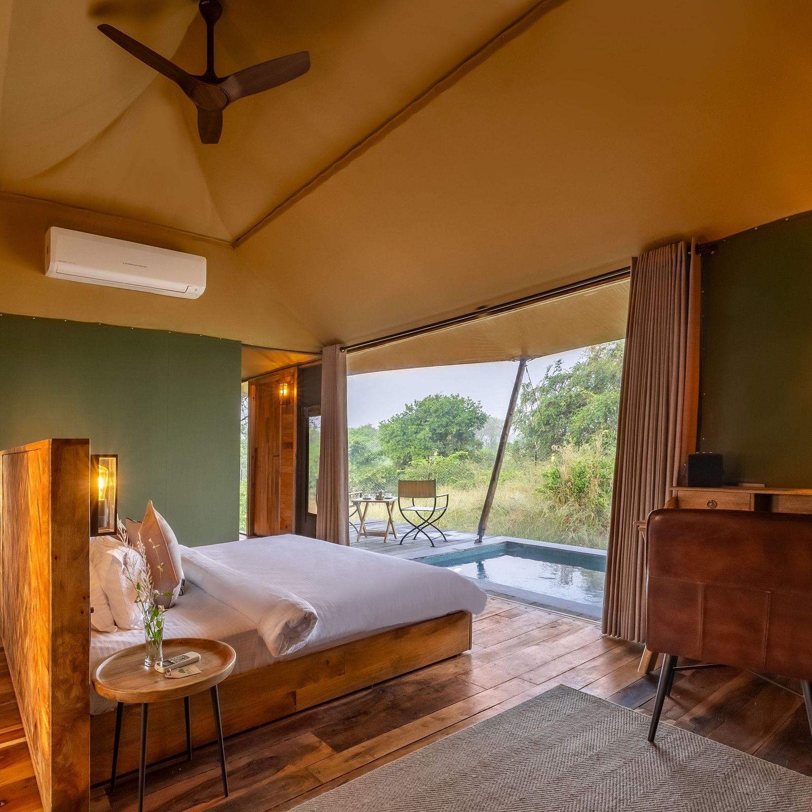 An interior of a room with double bed at Trees N Tigers, Tadoba.