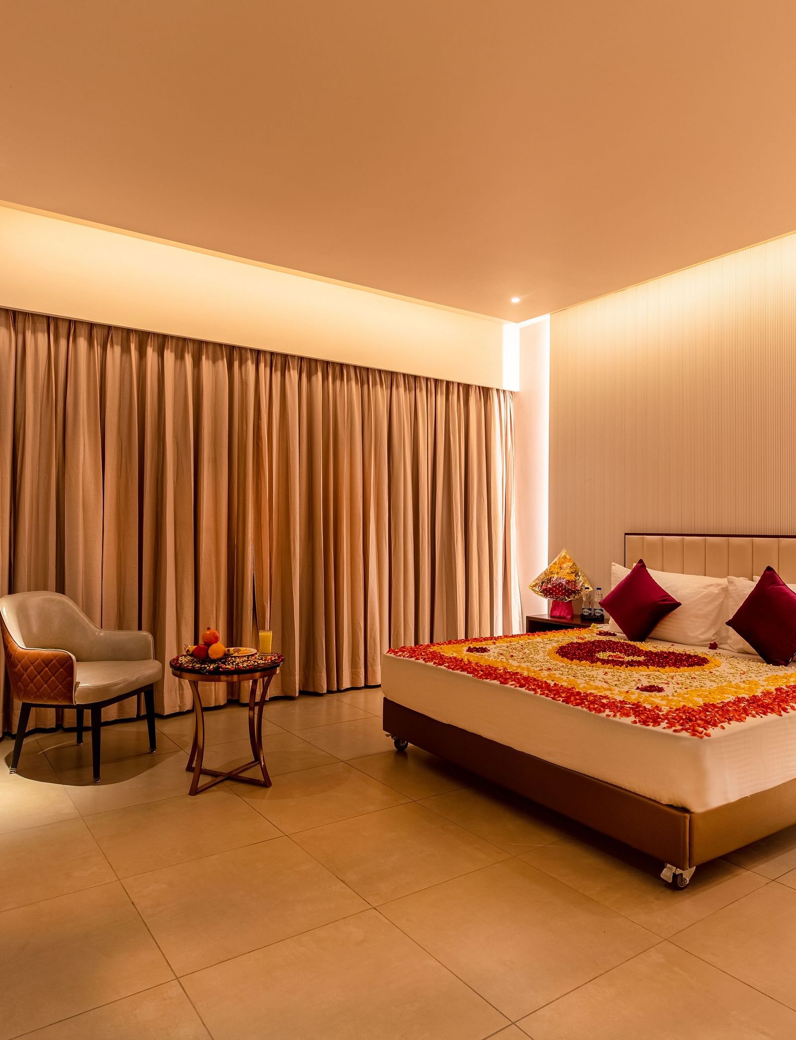An image of a room featuring a bed adorned with flowers, with a television positioned in front at M Pro Palace.