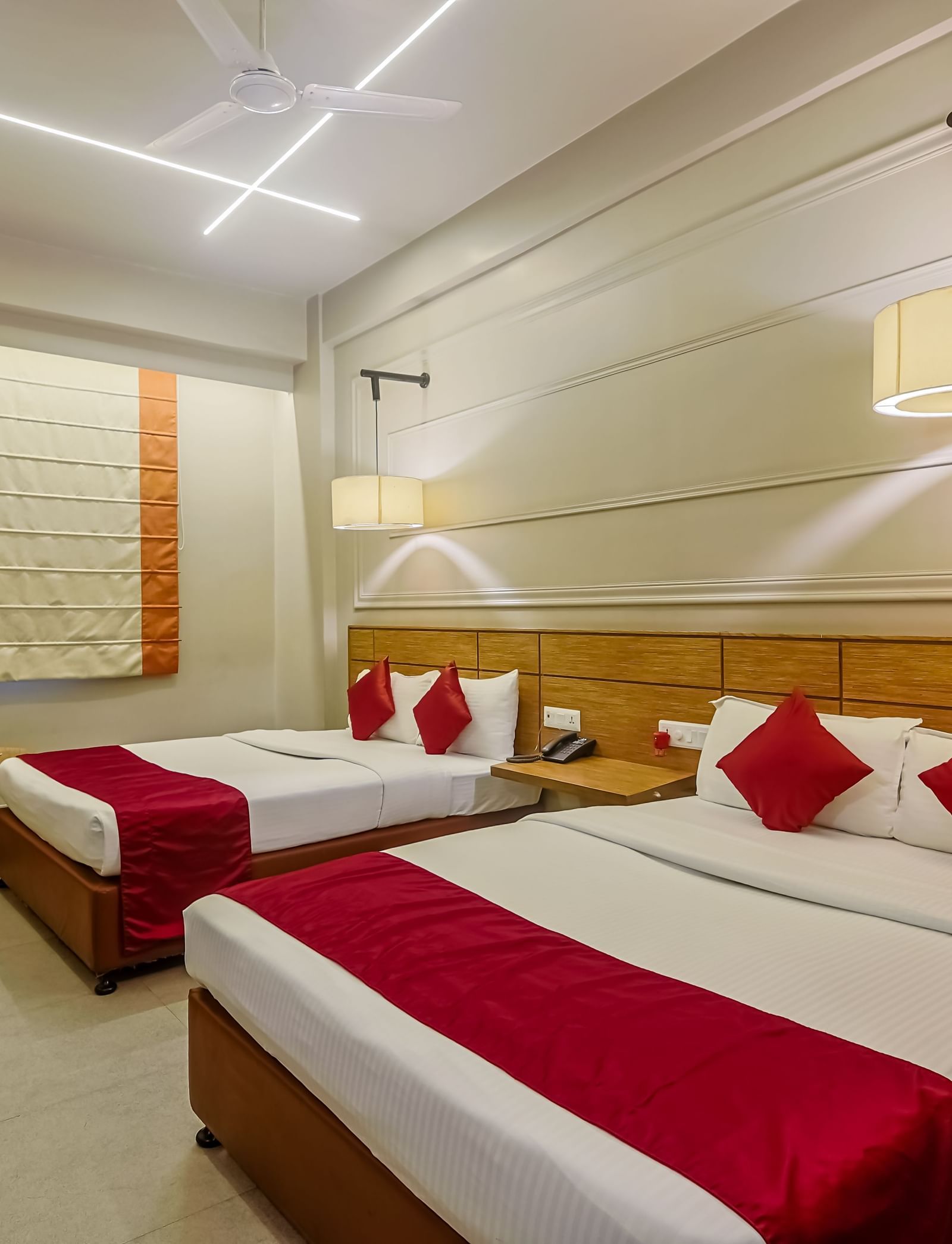 Spacious room with two beds and stylish decor at Max Hotel Prayagraj.
