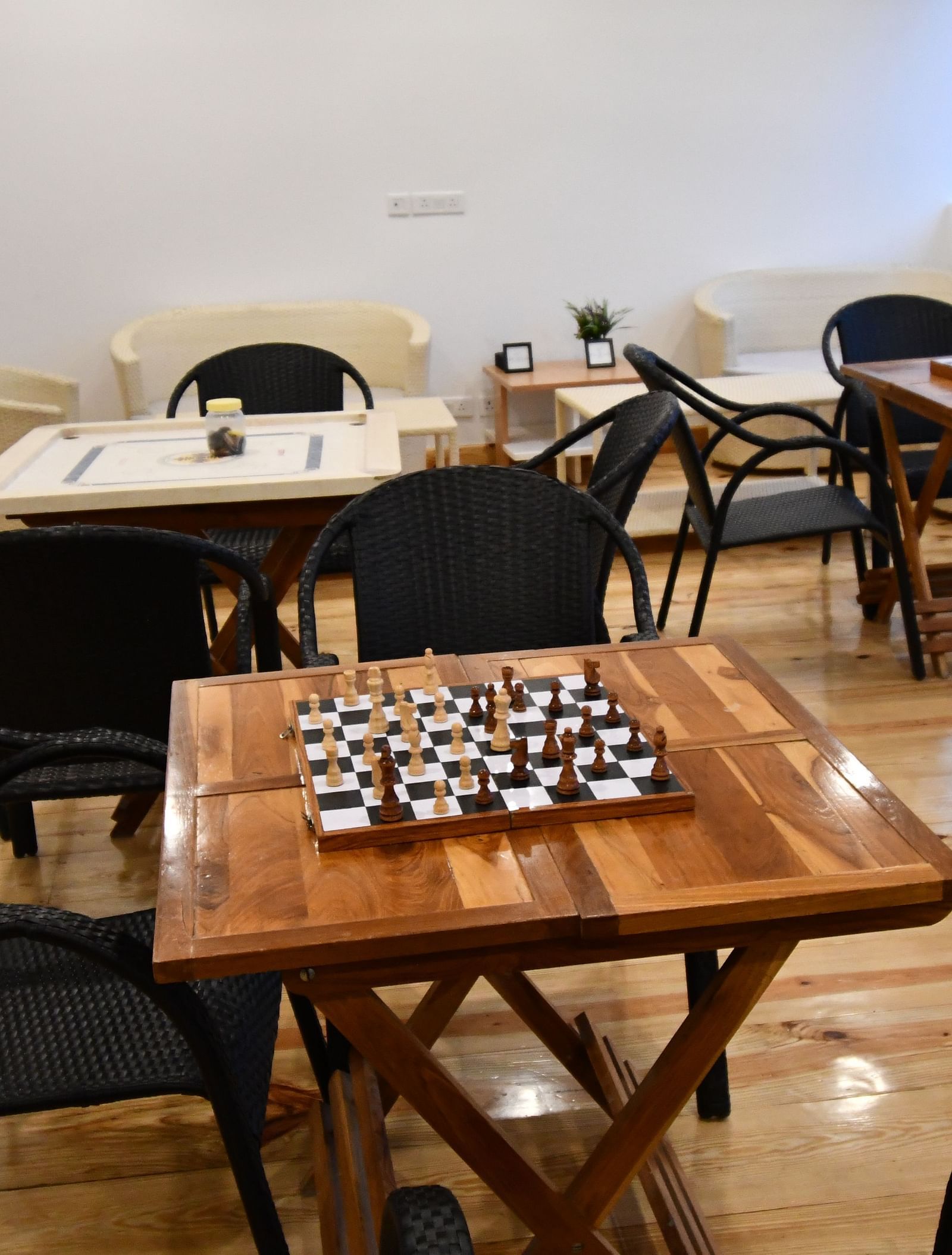 image of the indoor games area featuring a chess board kept on a wooden table at the tattva, joshimath