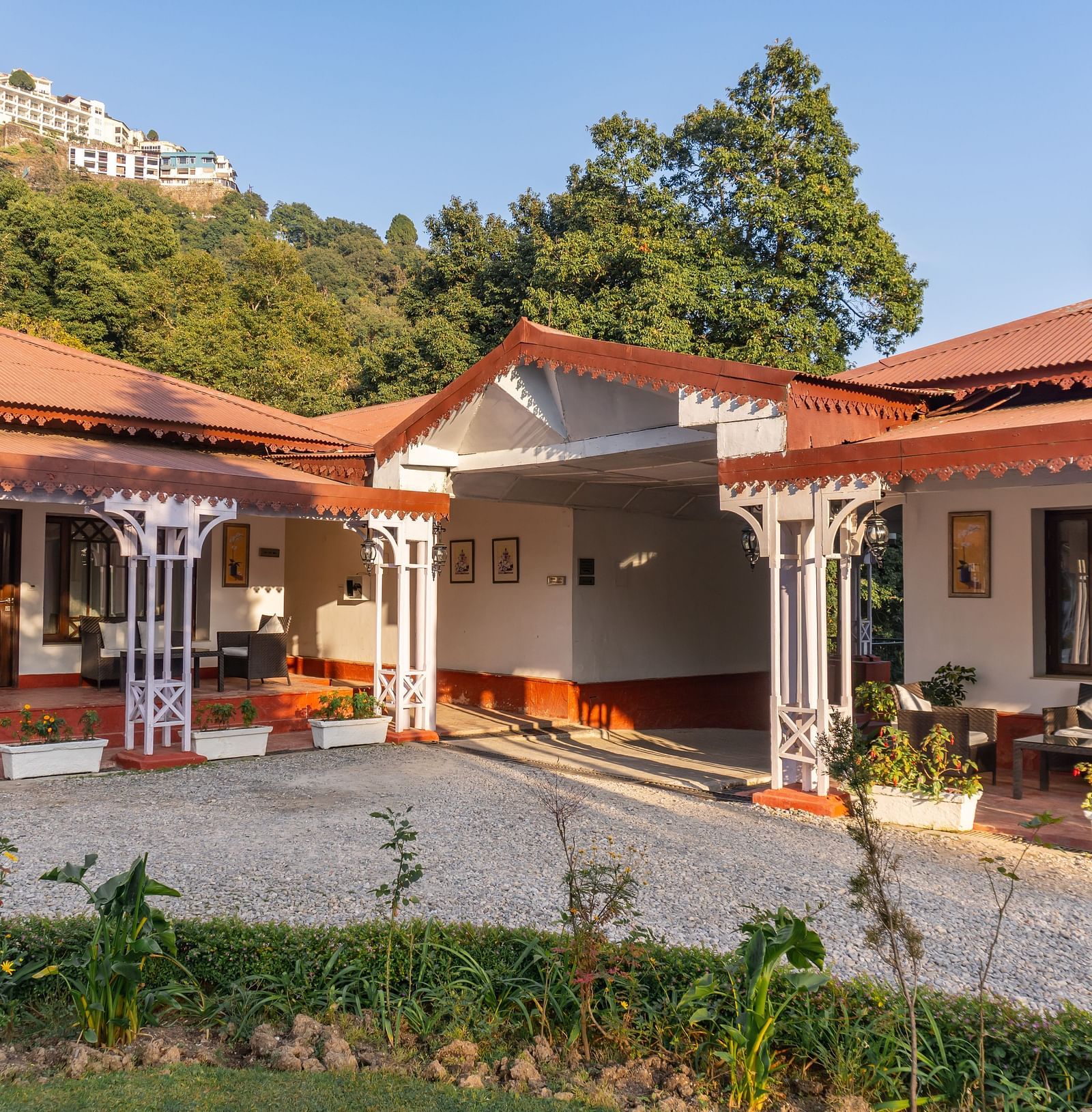 a facade image of our hotel in Mussoorie during a sunrise - The Claridges Nabha Residence