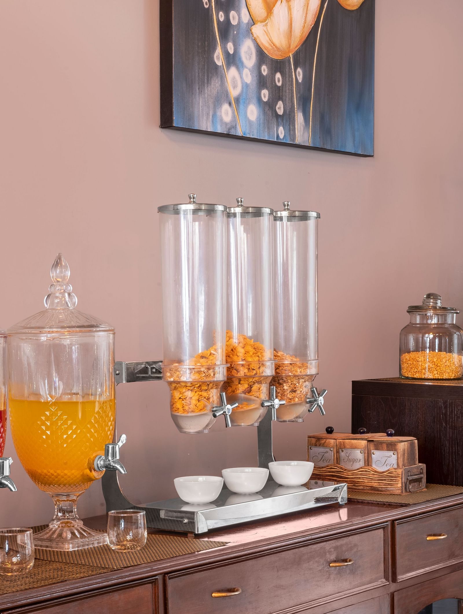 Self-serve breakfast counter with juice dispensers, cereals, and tea set-up, at BluSalzz Collection - Suvaasa Resort, Ramgarh.
