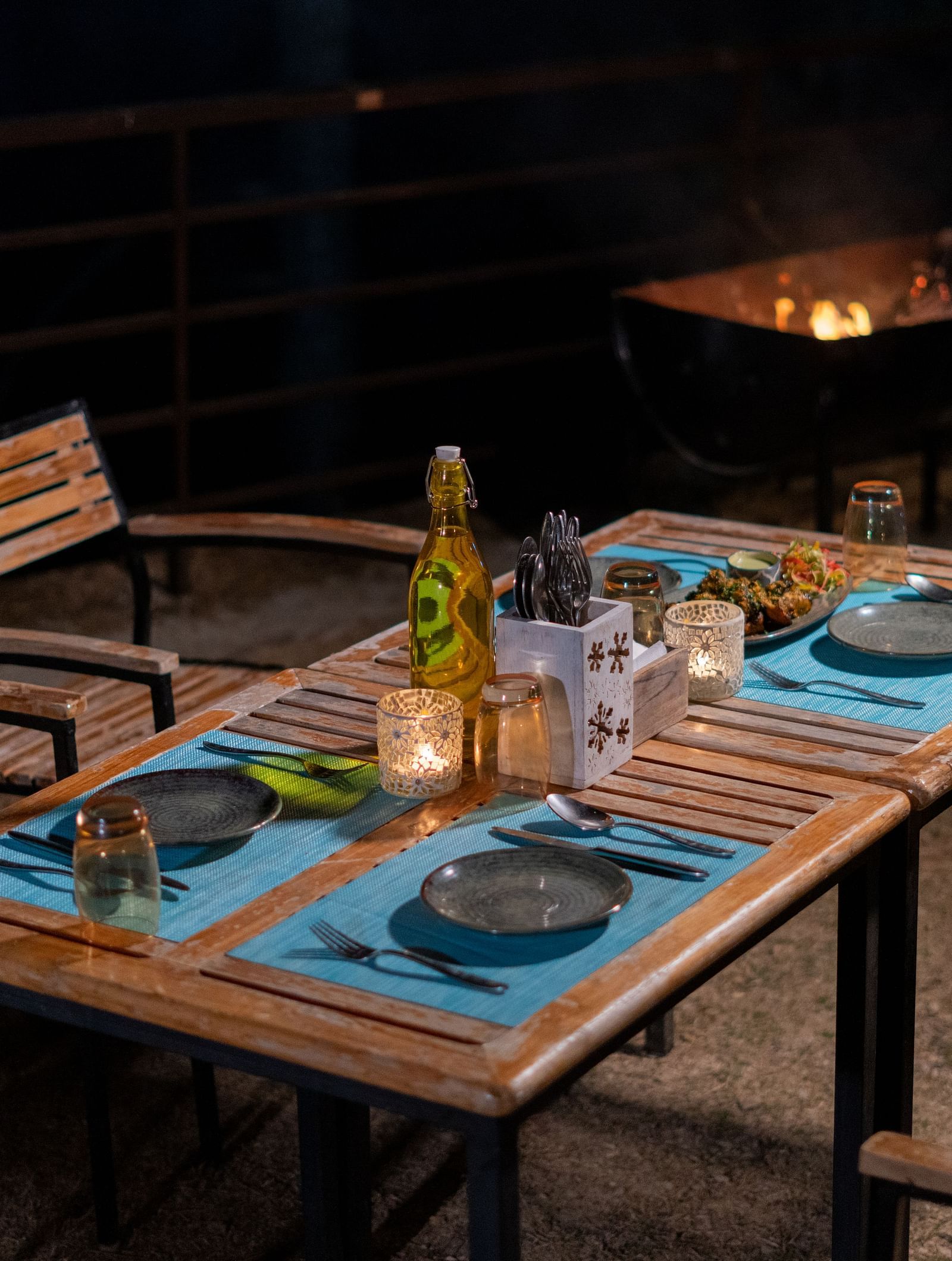 Outdoor dining space in the evening featuring chairs and a table at BluSalzz Escapade Resort, Lansdowne.