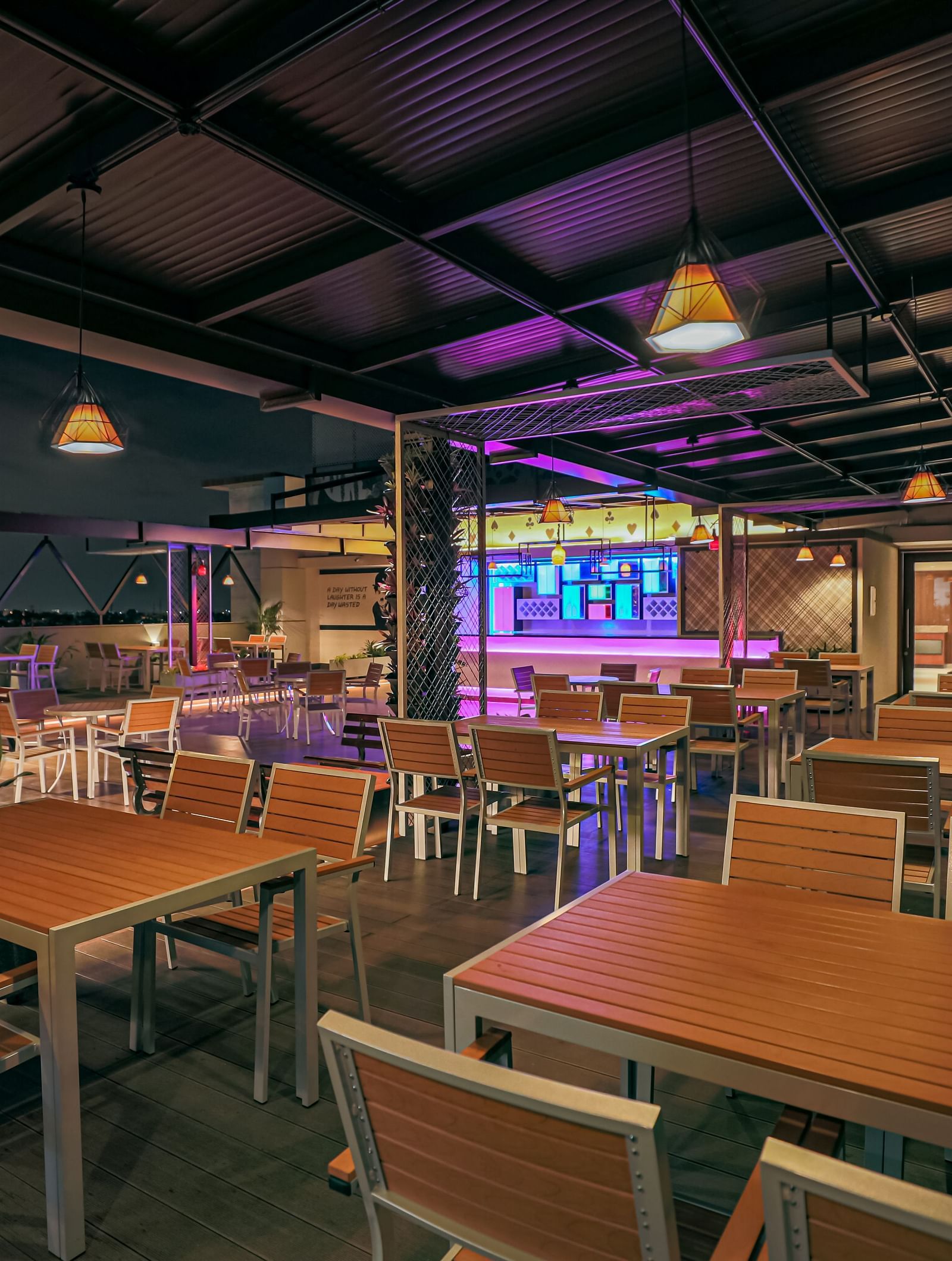 Image of a dining area with wooden tables and chairs at M Pro Palace.