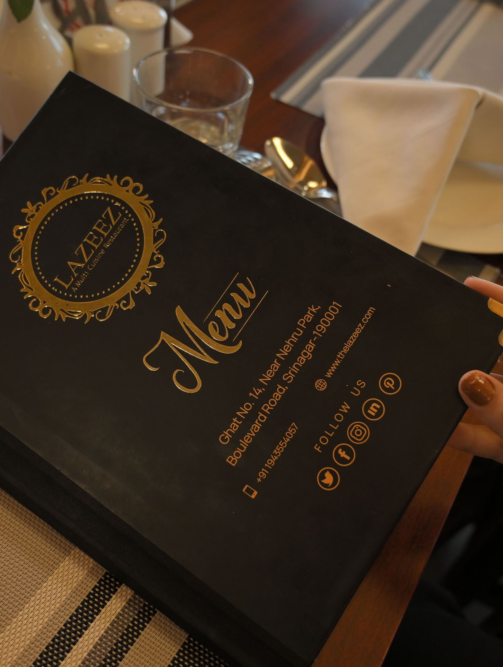 Guest holding the menu at Royal Comfort Regency highlighting a curated selection of dishes for a premium dining experience.