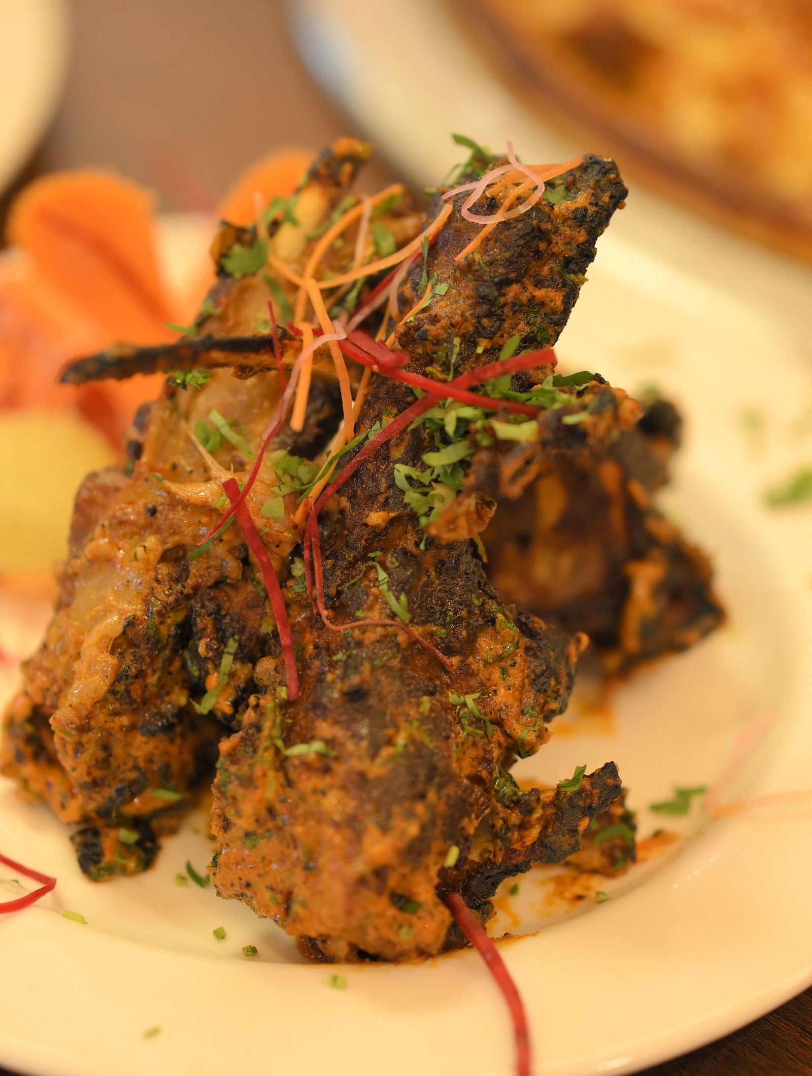 Crispy Indian starter garnished with herbs and spices, served hot at Royal Comfort Regency for an appetising beginning.