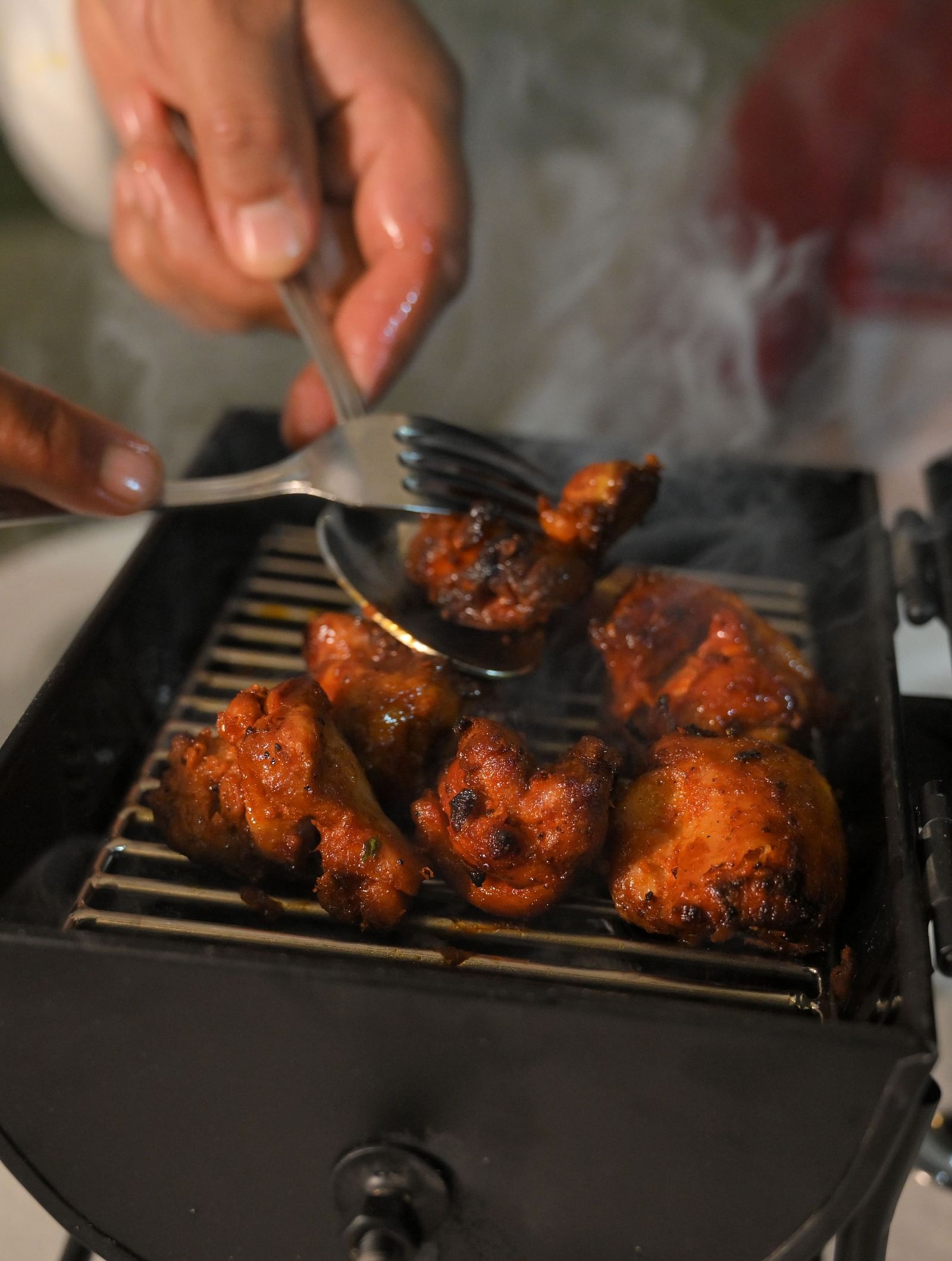 Chef grilling fresh tandoori delicacies live at Royal Comfort Regency, bringing authentic flavours straight to your table.
