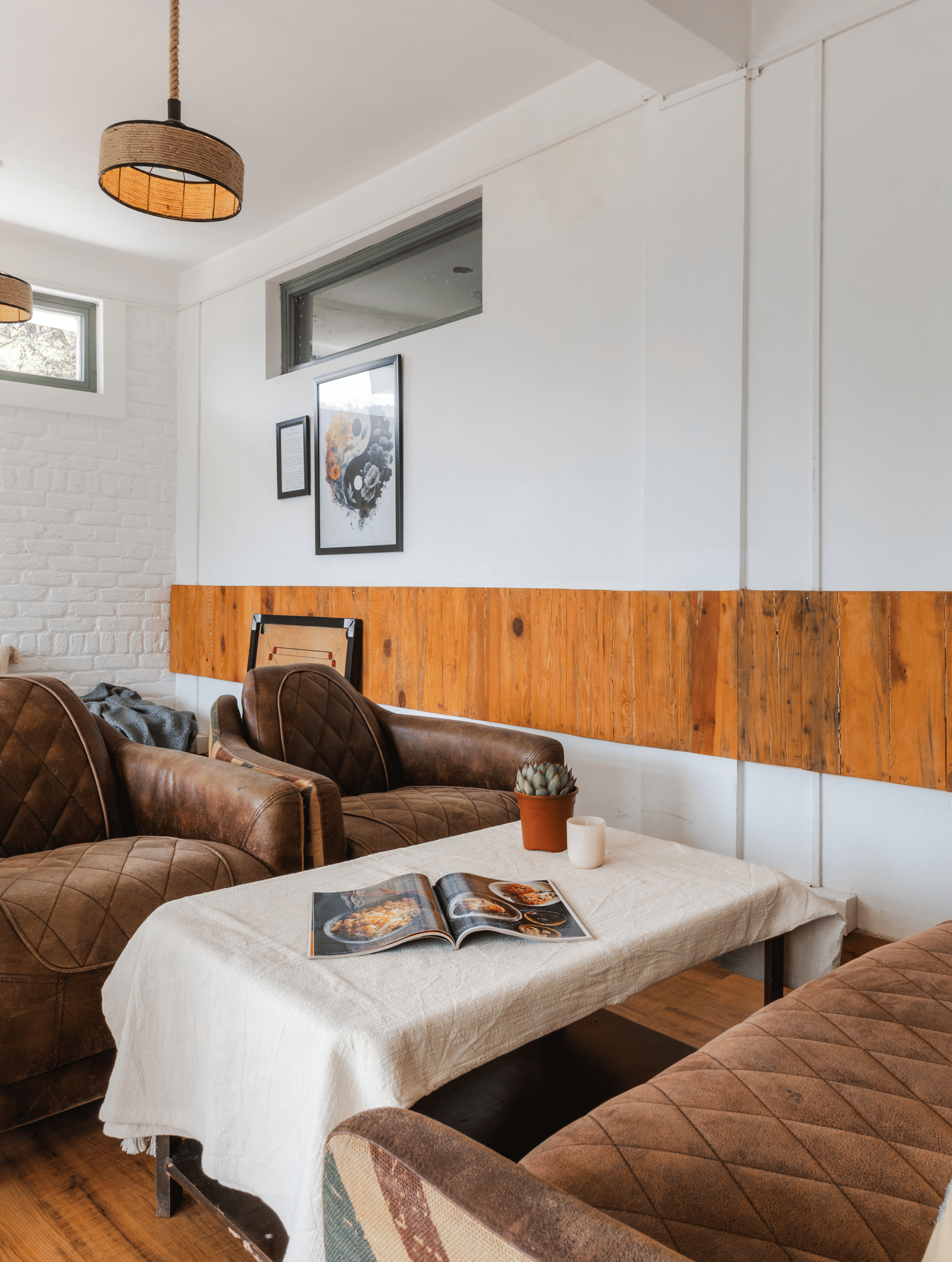 An indoor living area with a sofa and armchairs at Ziran Retreat.