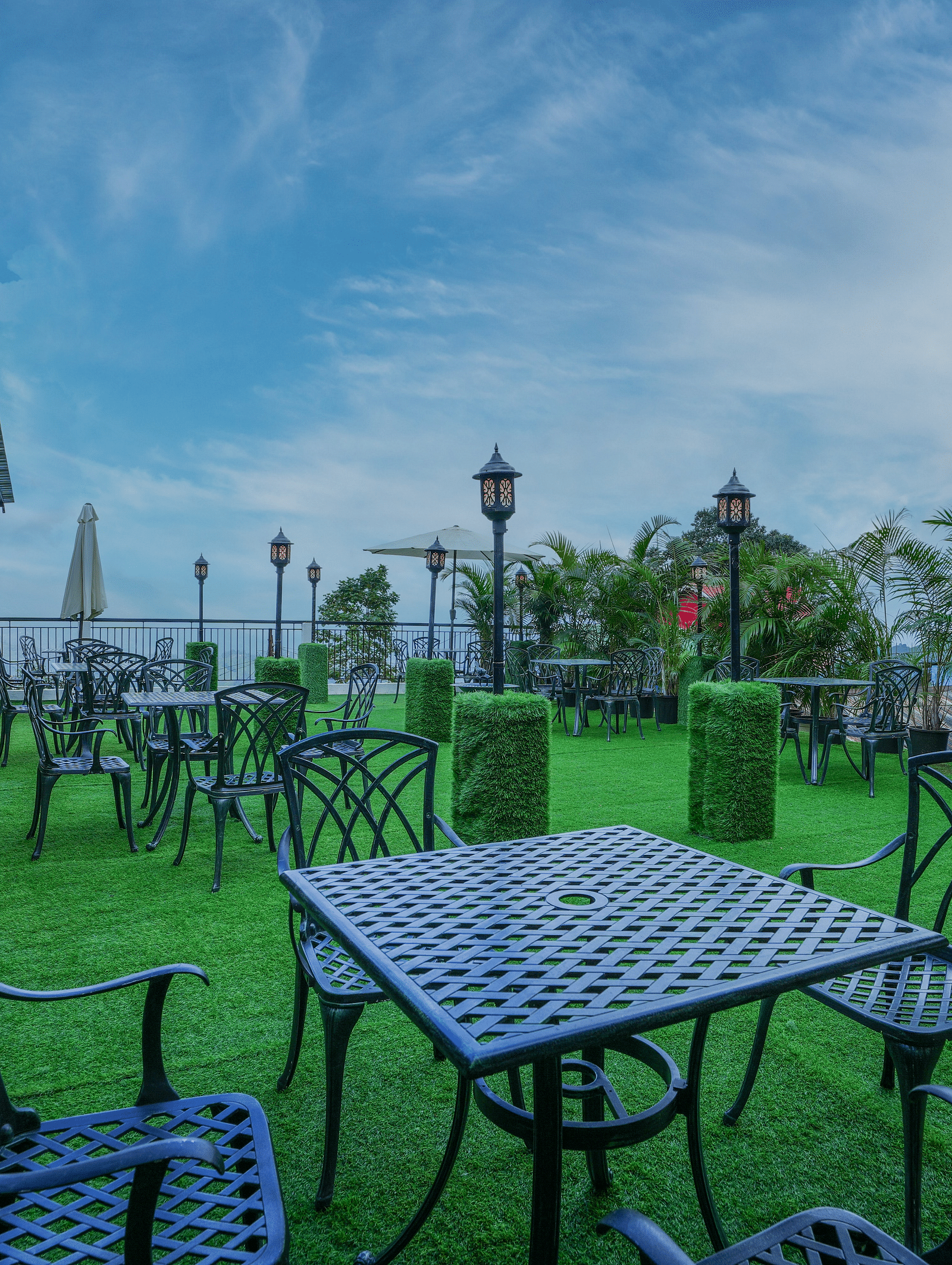  A table and chairs neatly arranged amidst a lush green lawn
