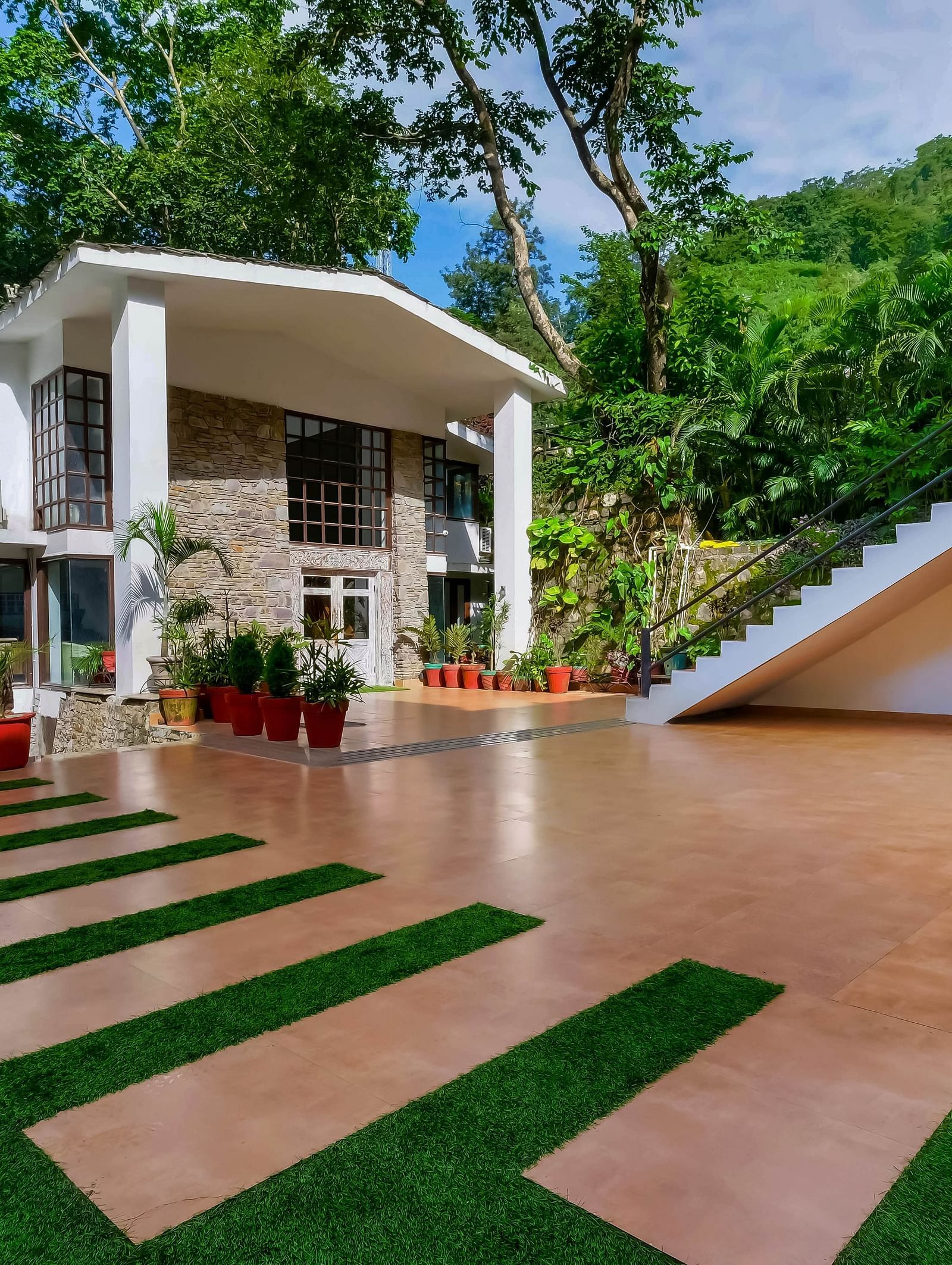 Facade of Summit By The Ganges Beach Resort & Spa, Rishikesh surpunded by greenery
