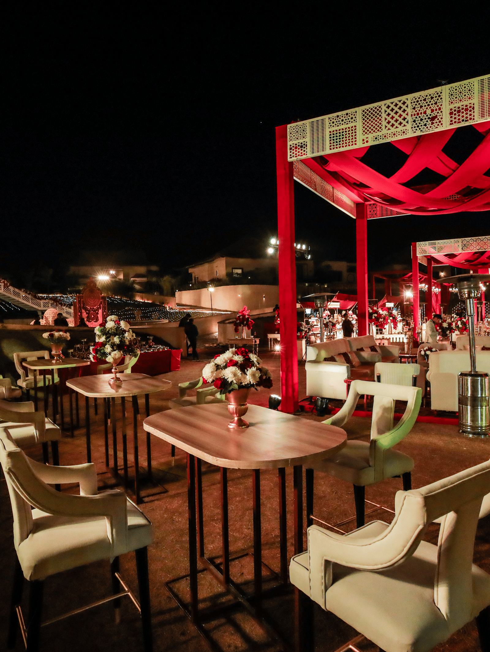 An outdoor dining area with tables chairs and an open structure at Ananta Spa and Resort, Jaipur