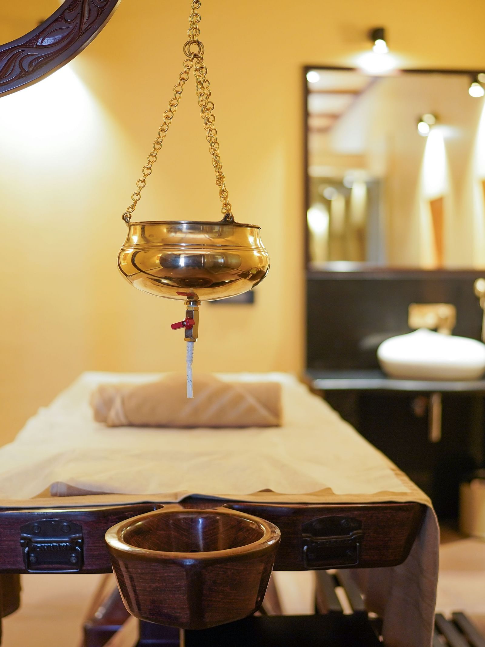 A close-up of a spa room featuring an ornate hanging lamp at Aamaghati Wildlife Resort.