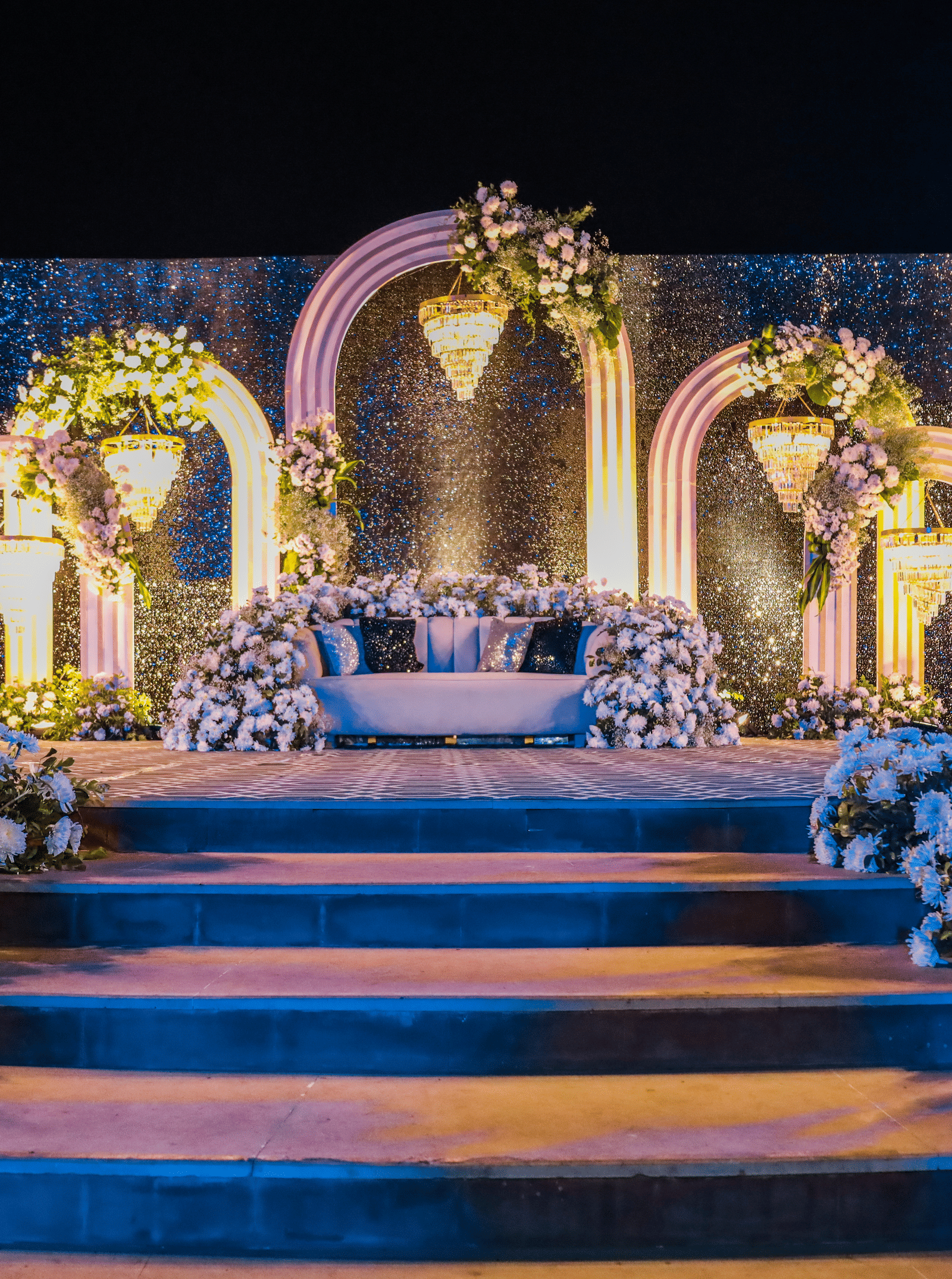 Decorated wedding stage with floral arrangements and arches at Ananta Spa and Resorts, Jaipur.