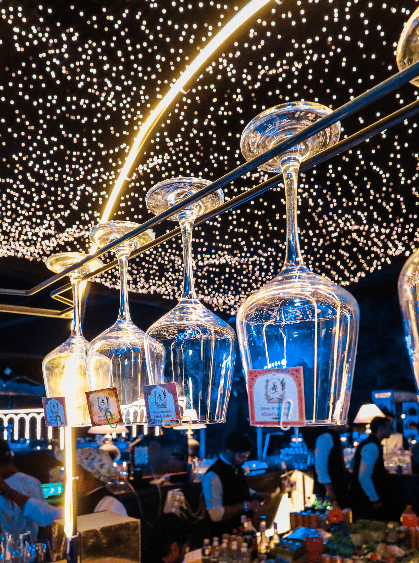Dining area decorated with string lights and hanging lanterns at Ananta Spa and Resorts, Jaipur.