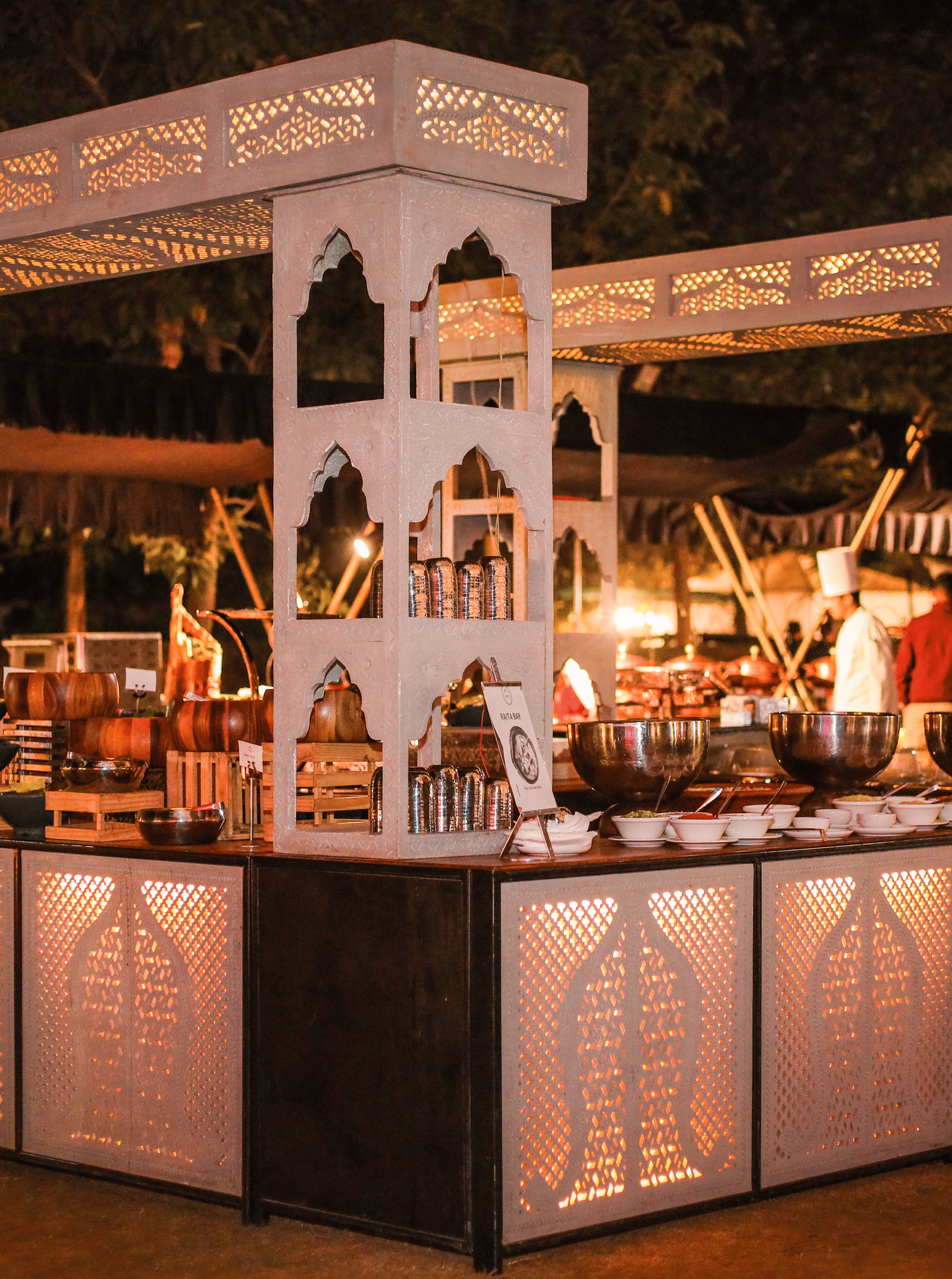 A service pavilion with food counters, serving areas and staff at Ananta Spa and Resort, Jaipur