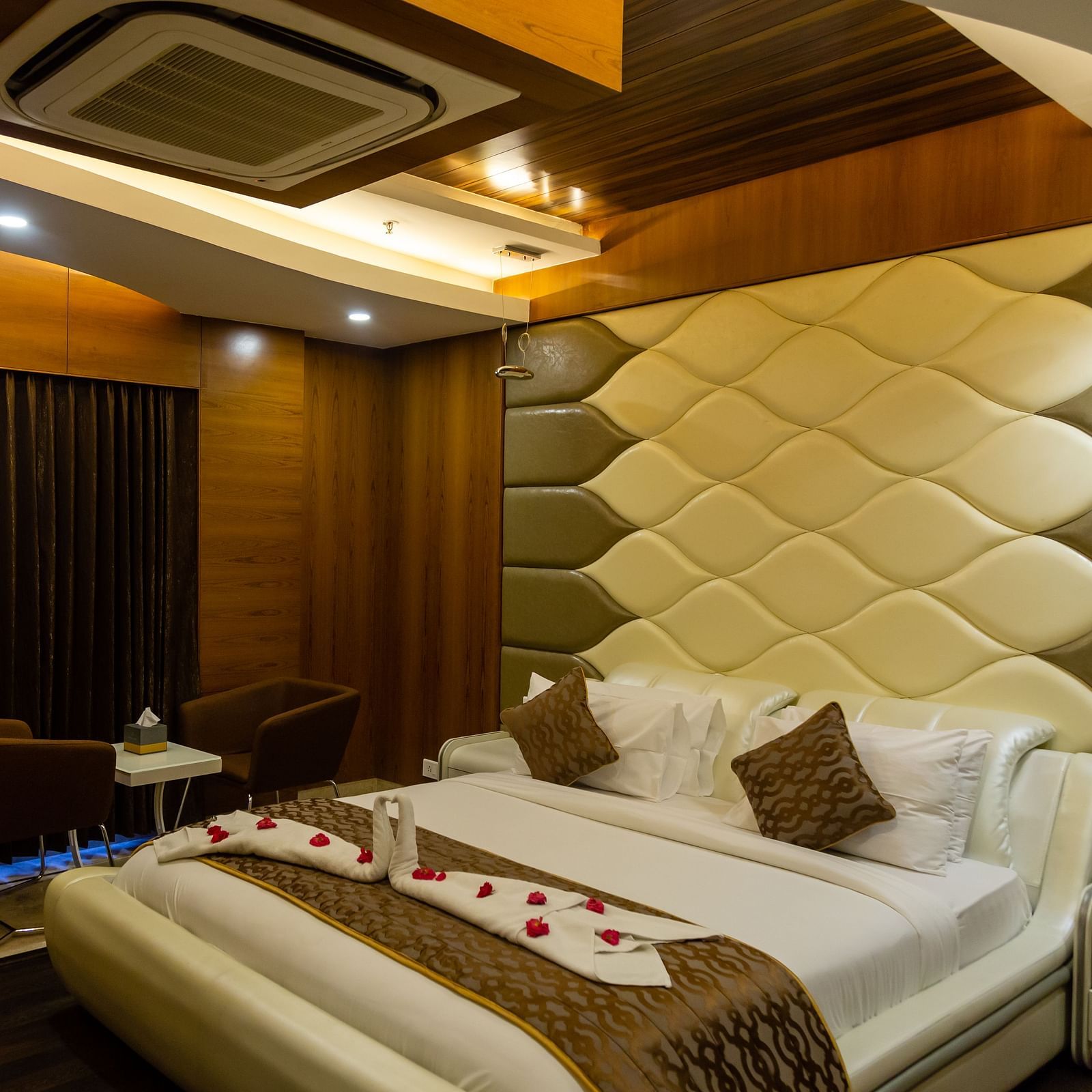 a bedroom with a false ceiling with overhead lighting and blackout curtains - Hotel Park Elanza, Chennai