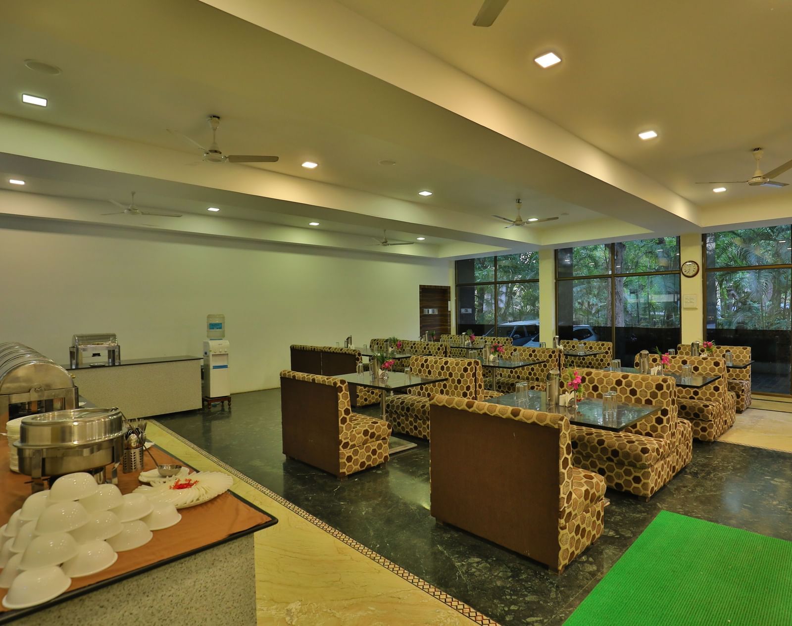 A large dining area with various seating areas, including sofas and low tables, and warm lighting - Retreat Heritage, Lonavala