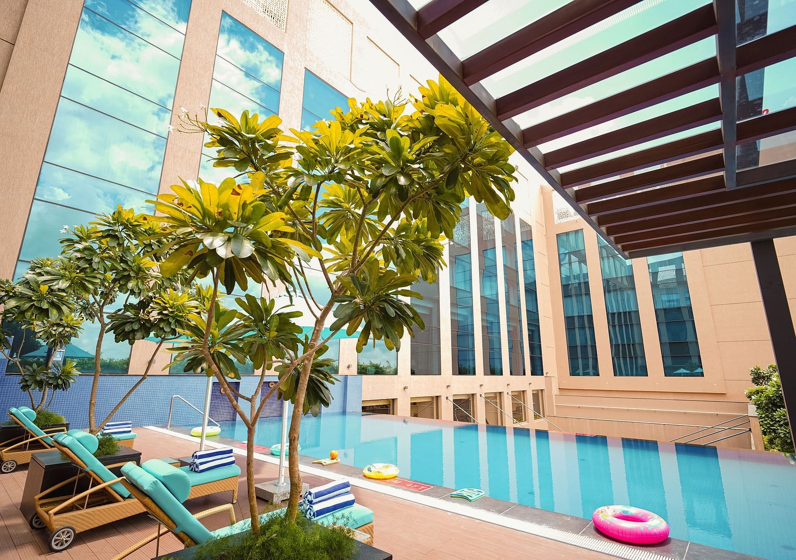 A playful pool area featuring colourful inflatables, ideal for a day packed with fun under the warm sun - Grand Madurai by GRT Hotels