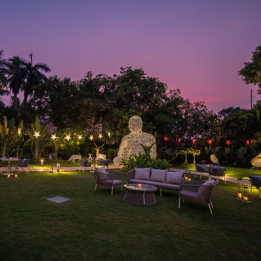 A lush garden with seating arrangements at Heritage Village Resorts & Spa.