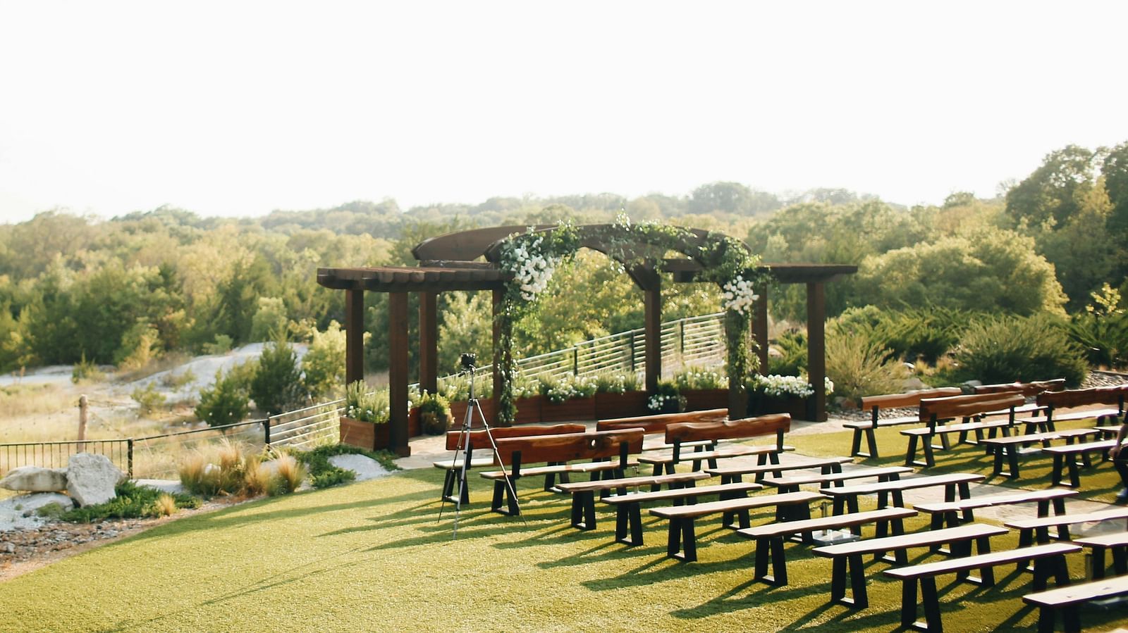 An aerial long shot of the wedding lawn, beautifully blanketed in lush greenery