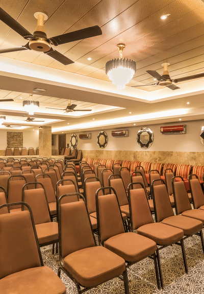 A shot of brown chairs at the banquet hall in Summit arranged systematically for an corporate event.