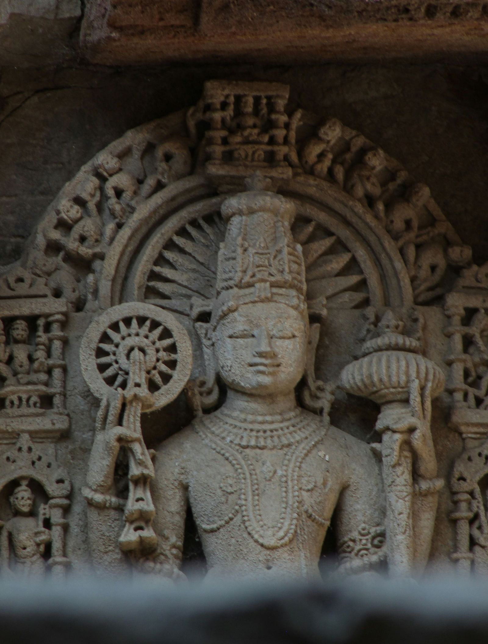 image of a stone carving of a goddess in a cave with dim lighting
