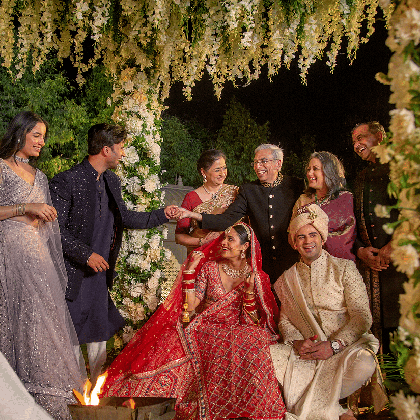 Family gathered around the bride and groom at a wedding ceremony - Heritage Village Resorts & Spa, Manesar