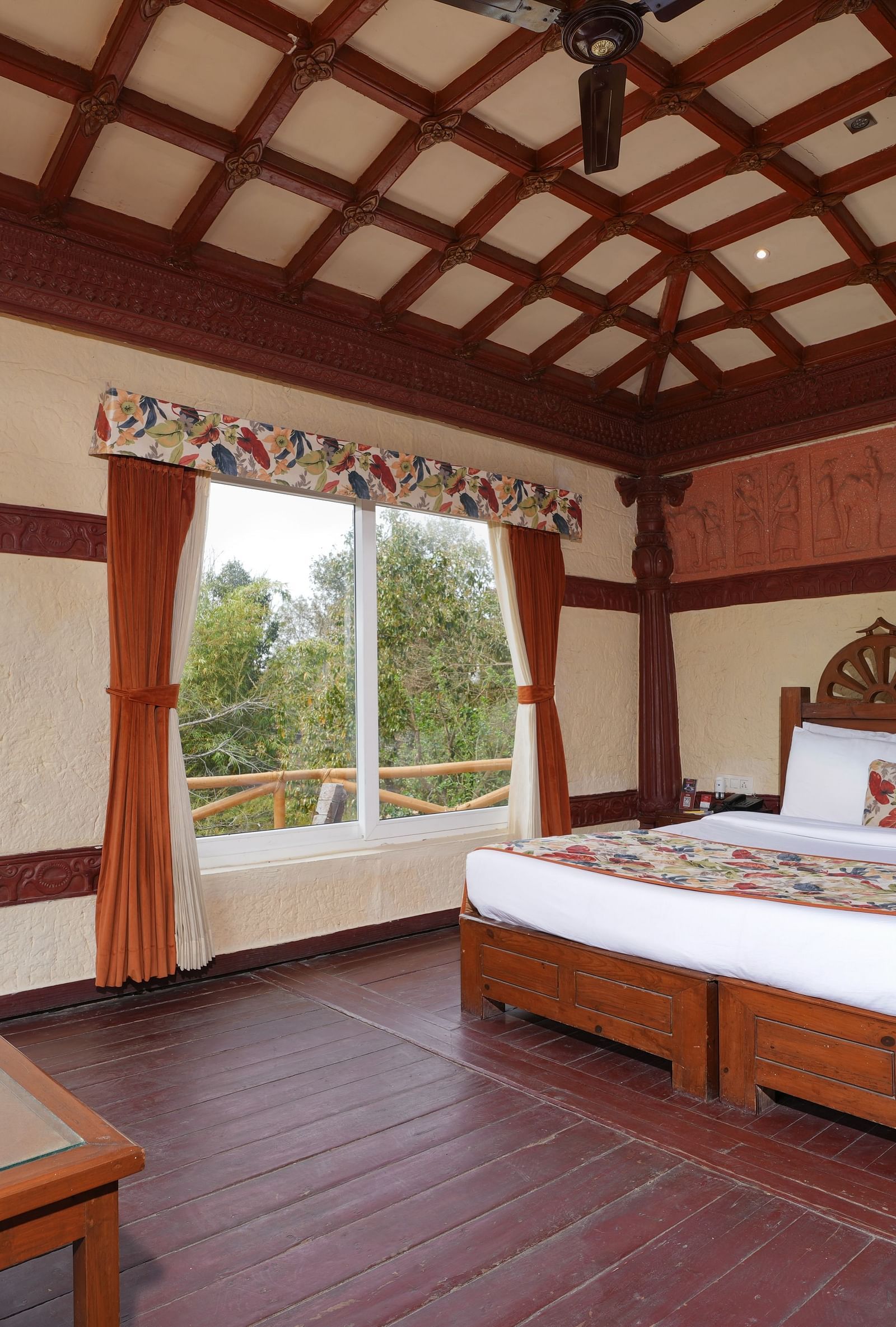 Ethnic villa offering a spacious bedroom and large windows with curtains at Summit Green Lake Tea Resort & Spa, Kaziranga