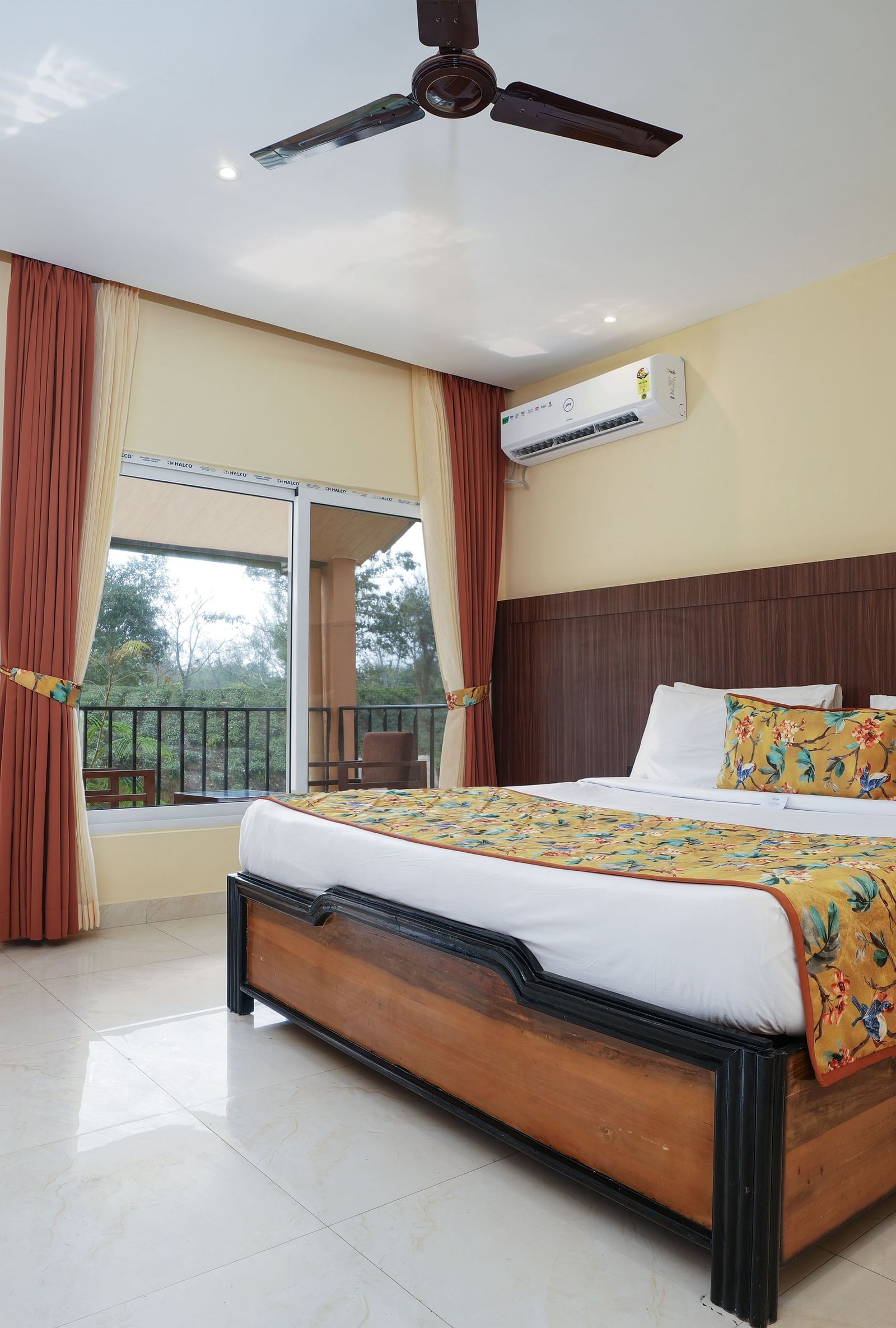 Premium room with balcony offering a nature view and spacious bed at Summit Green Lake Tea Resort & Spa, Kaziranga