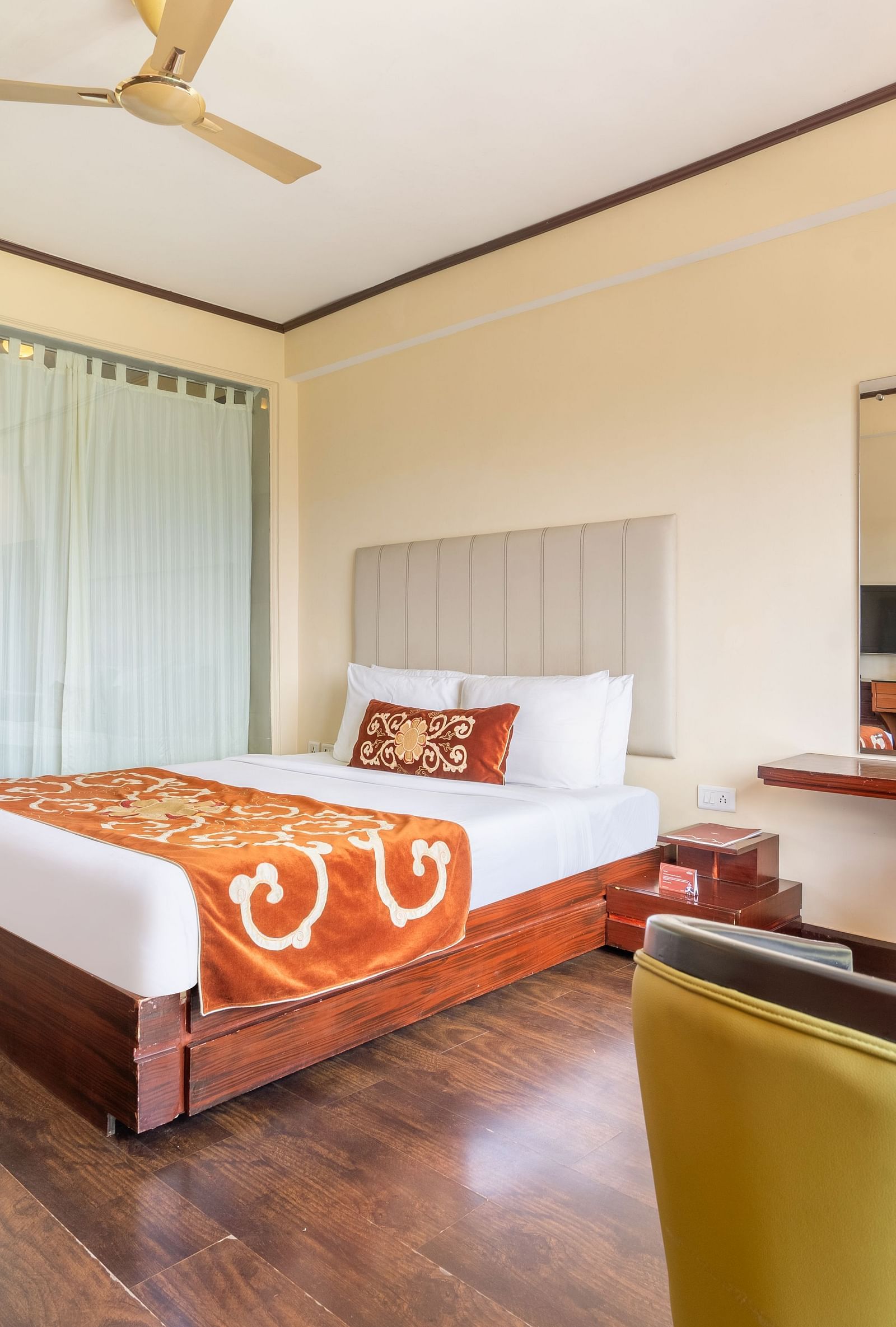 king size bed and chairs of premium room at Summit Lillium Hotel & Spa, Kalimpong