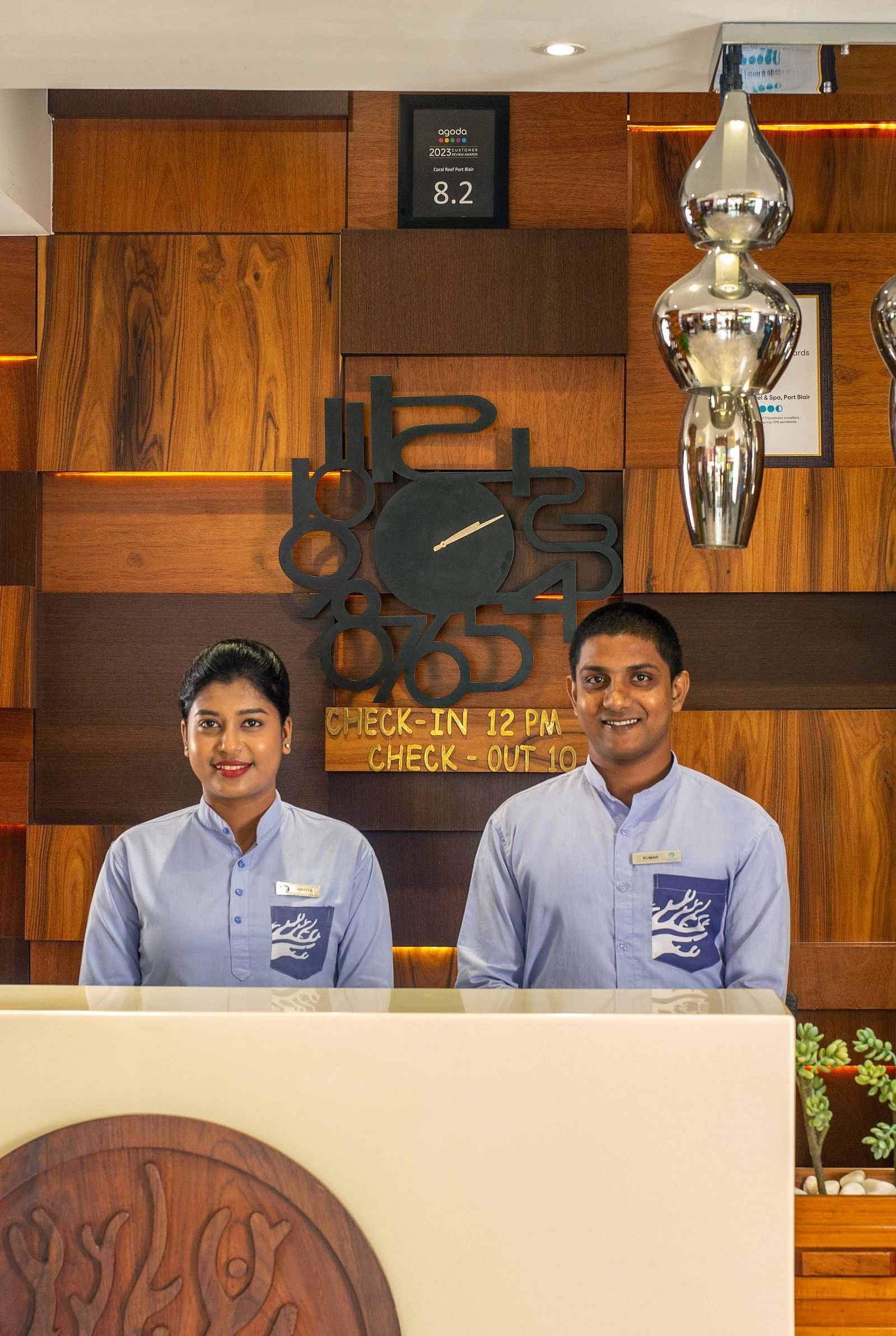 Image of two receptionists at the reception desk of Coral Reef Hotel and Spa in Port Blair