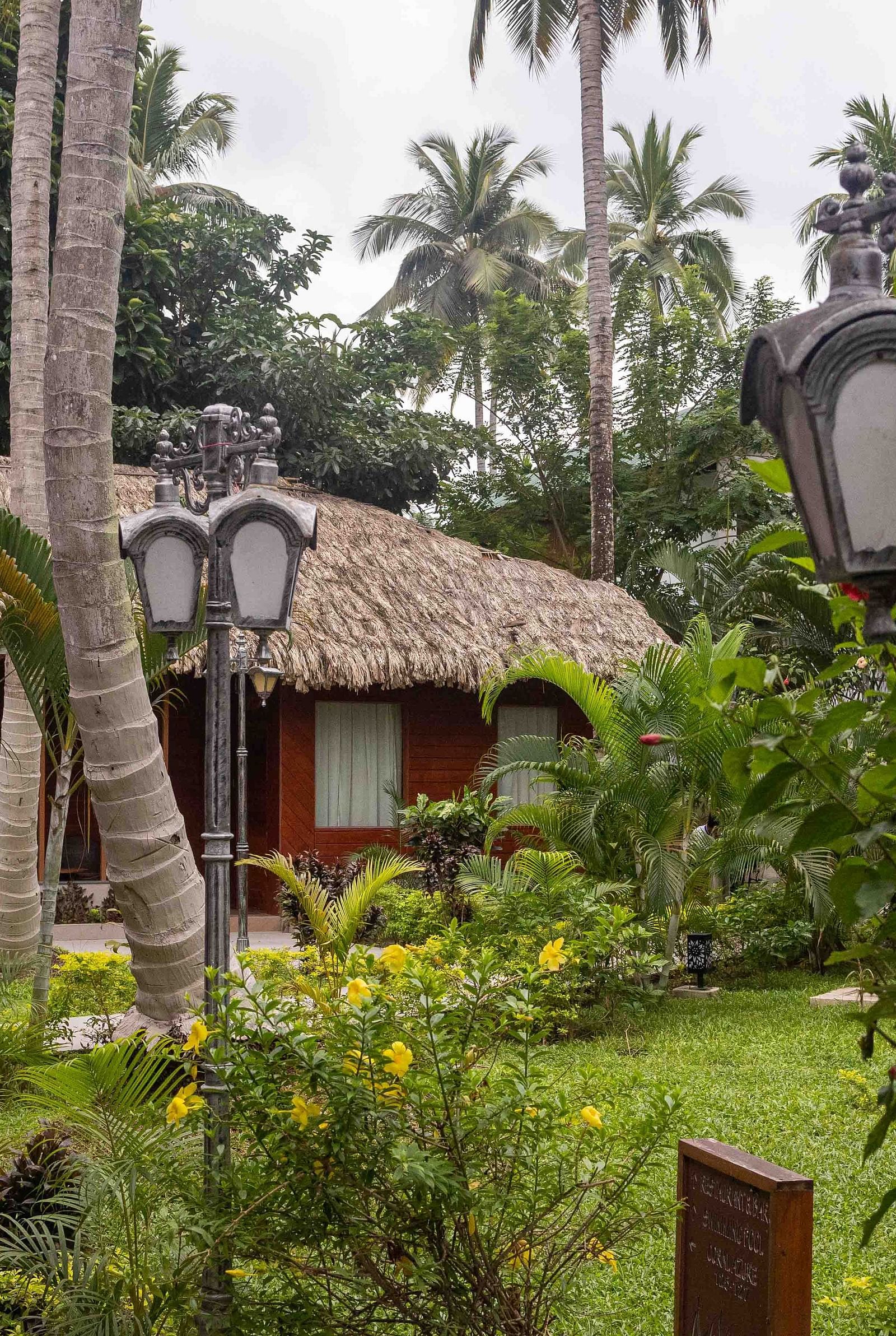 Image of the facade of Coral Azure at Coral Reef Resort and Spa in Havelock featuring cosy huts with bricked pavements and small gardens on the sides